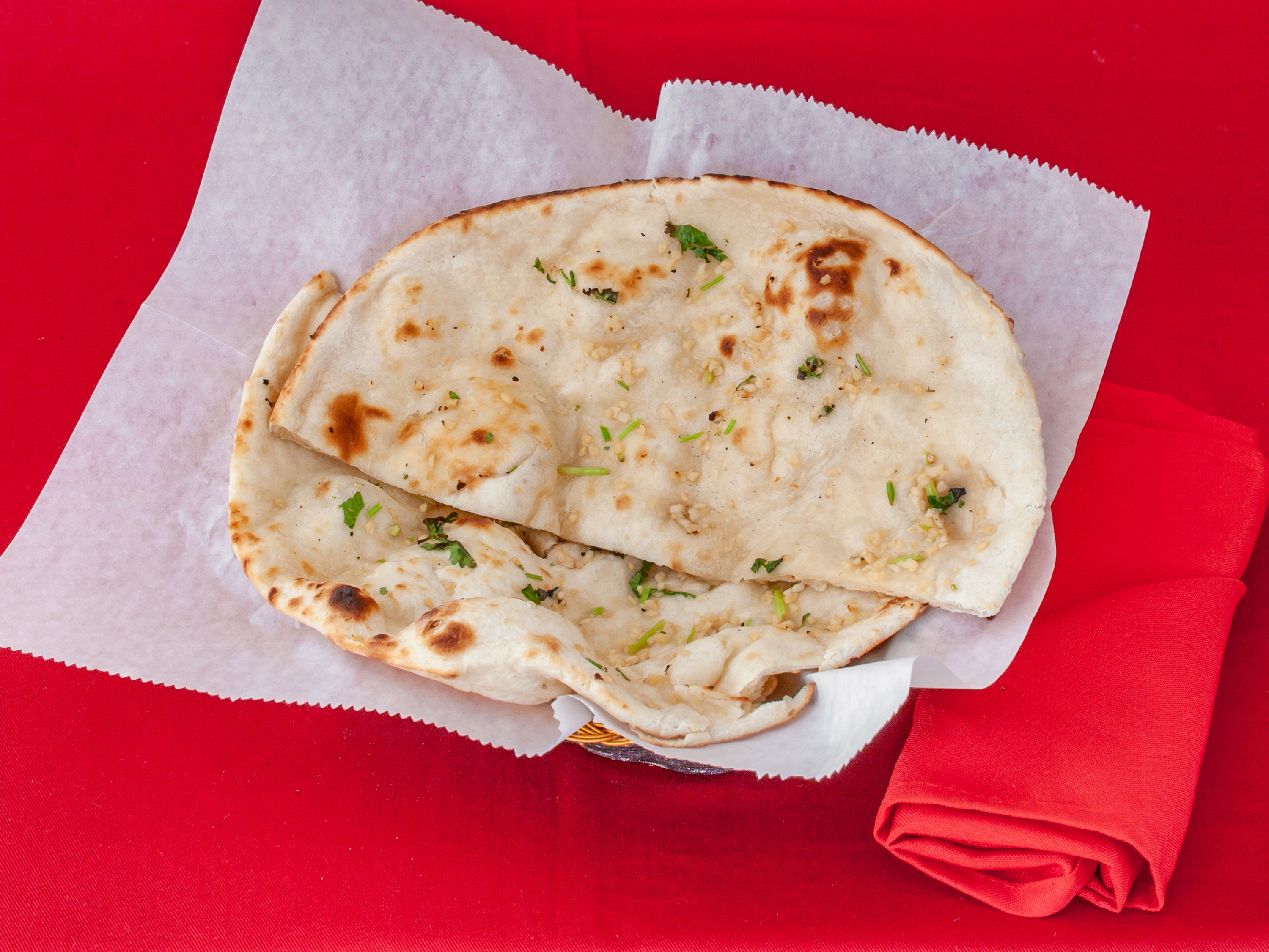 Order 24. Garlic Naan food online from Ambar Indian Restaurant store, Champaign on bringmethat.com
