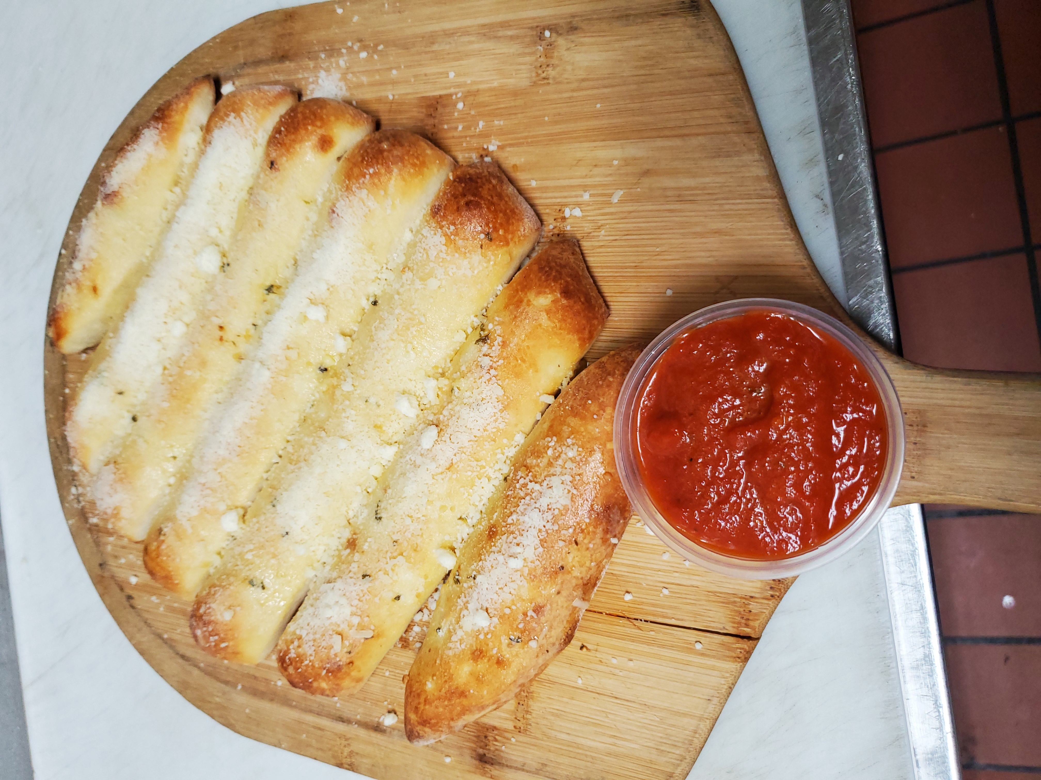 Order Garlic Parmesan Bread Sticks food online from Alessandro's Place store, Los Angeles on bringmethat.com