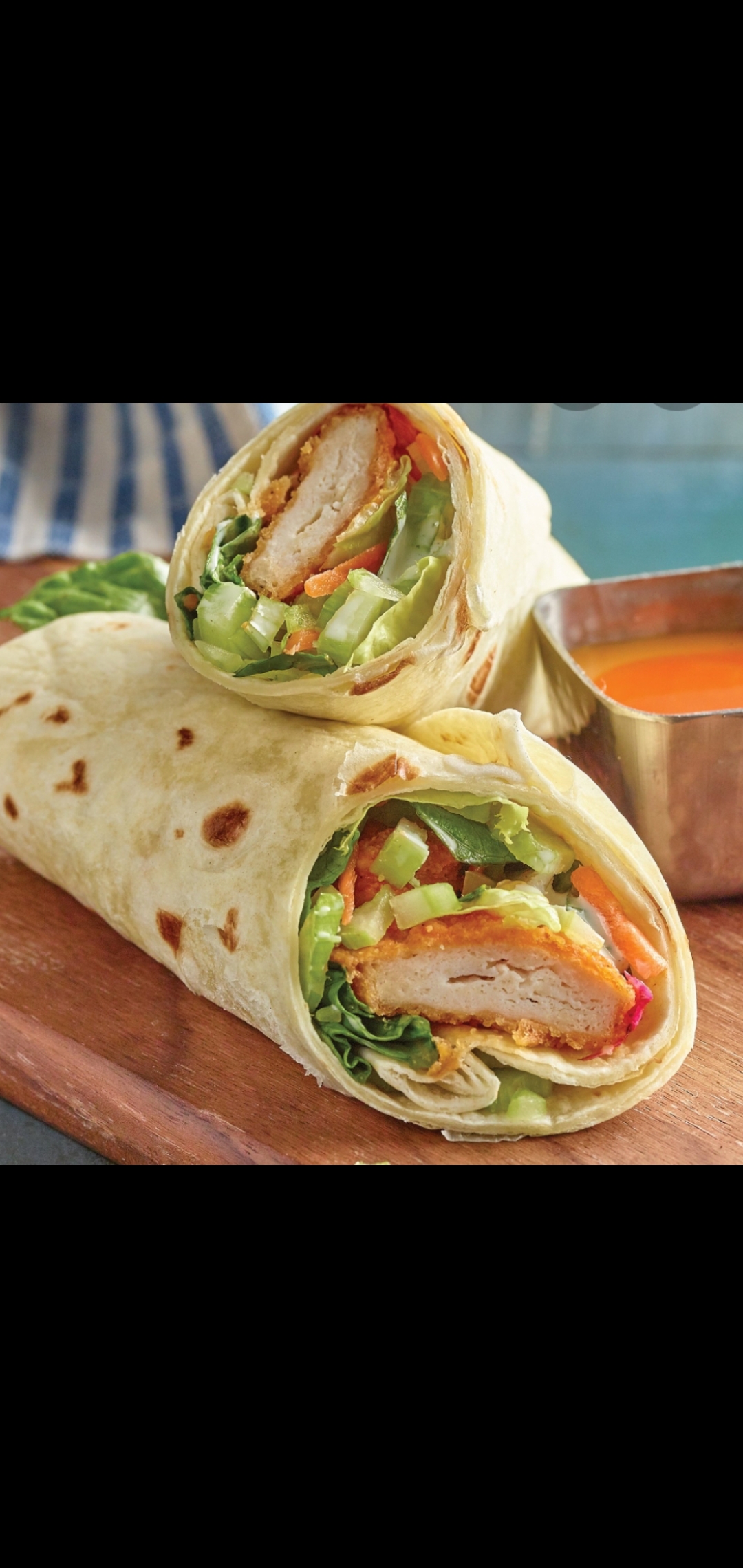Order  Spicy Chicken Cutlet Wrap (spicy chicken cutlet cheese lettuce and tomatoes) food online from American Gourmet Foods Deli store, New York on bringmethat.com