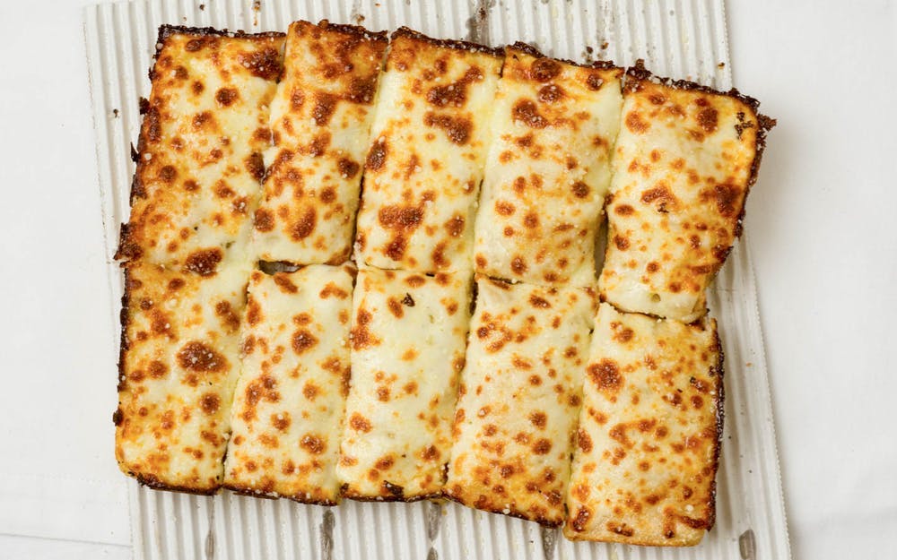 Order Cheesy Bread with Sauce - Small (10 Pieces) food online from Sorrento Pizza store, Utica on bringmethat.com