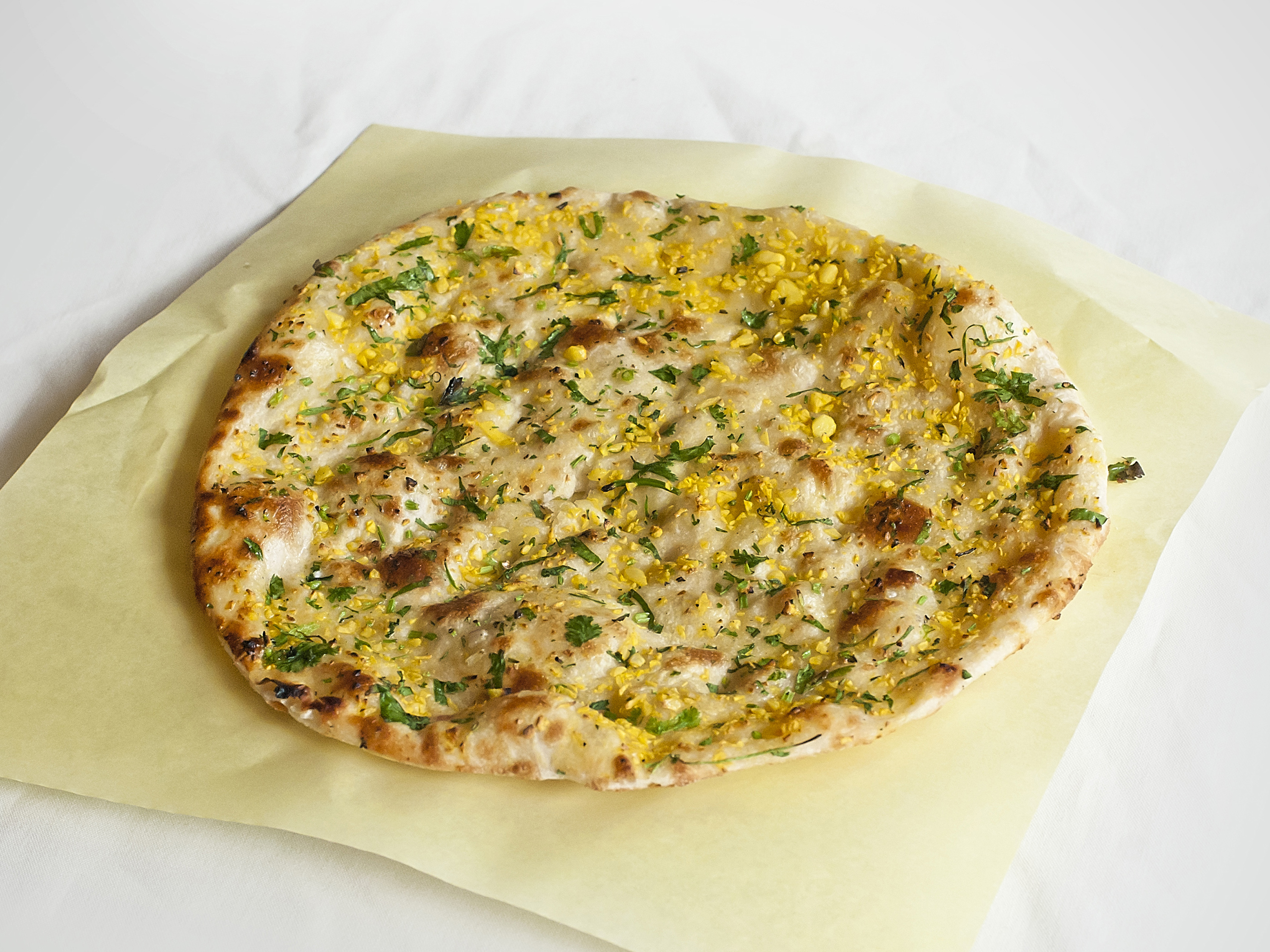 Order 68. Garlic Naan food online from Biryani Tika Kabab store, Oakland on bringmethat.com
