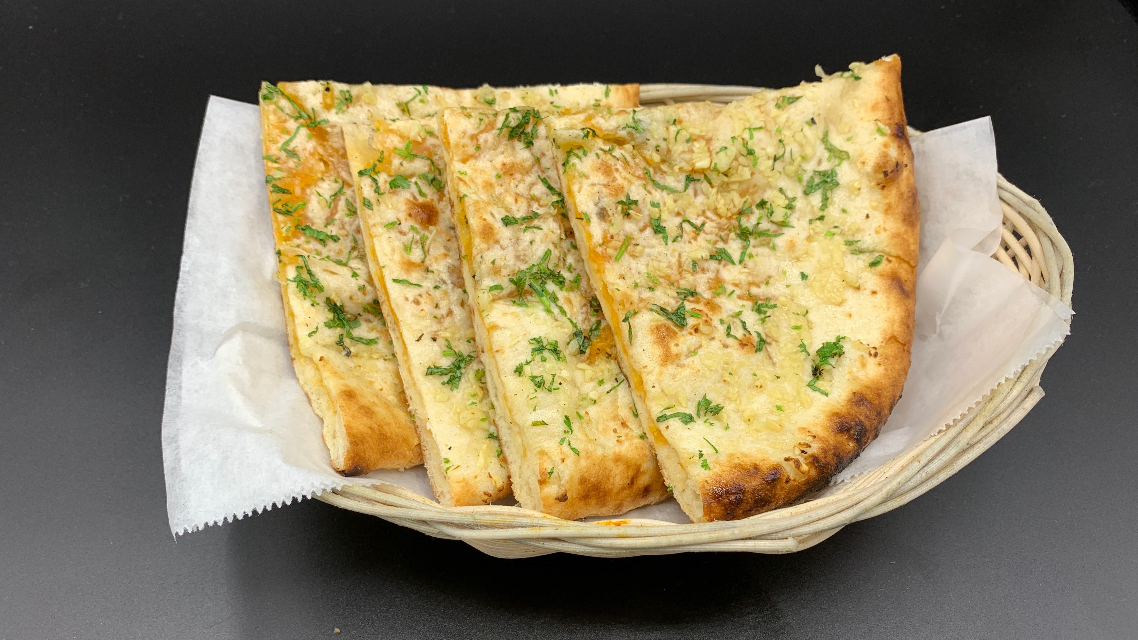 Order Garlic Cheese Naan food online from Masala Desi Cafe store, Burlingame on bringmethat.com