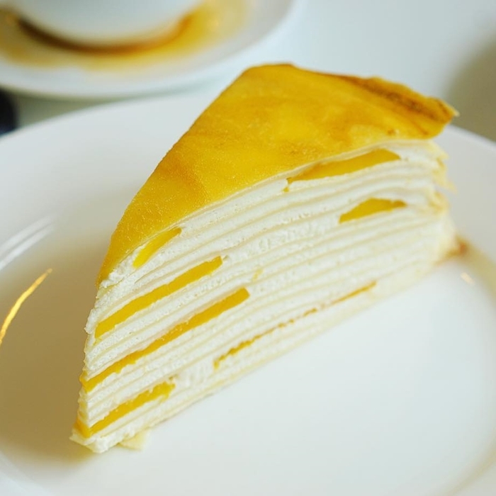 Order Mango Mille Crepe Cake  food online from Jade Tree Asian Bistro store, Providence on bringmethat.com