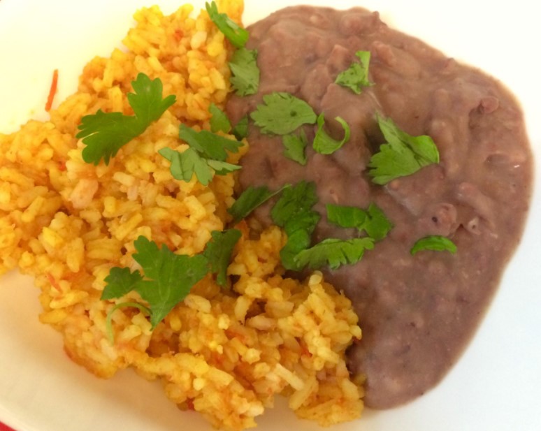 Order ½ Mexican Rice and ½ Refried Beans food online from Janik's Cafe store, Chicago on bringmethat.com