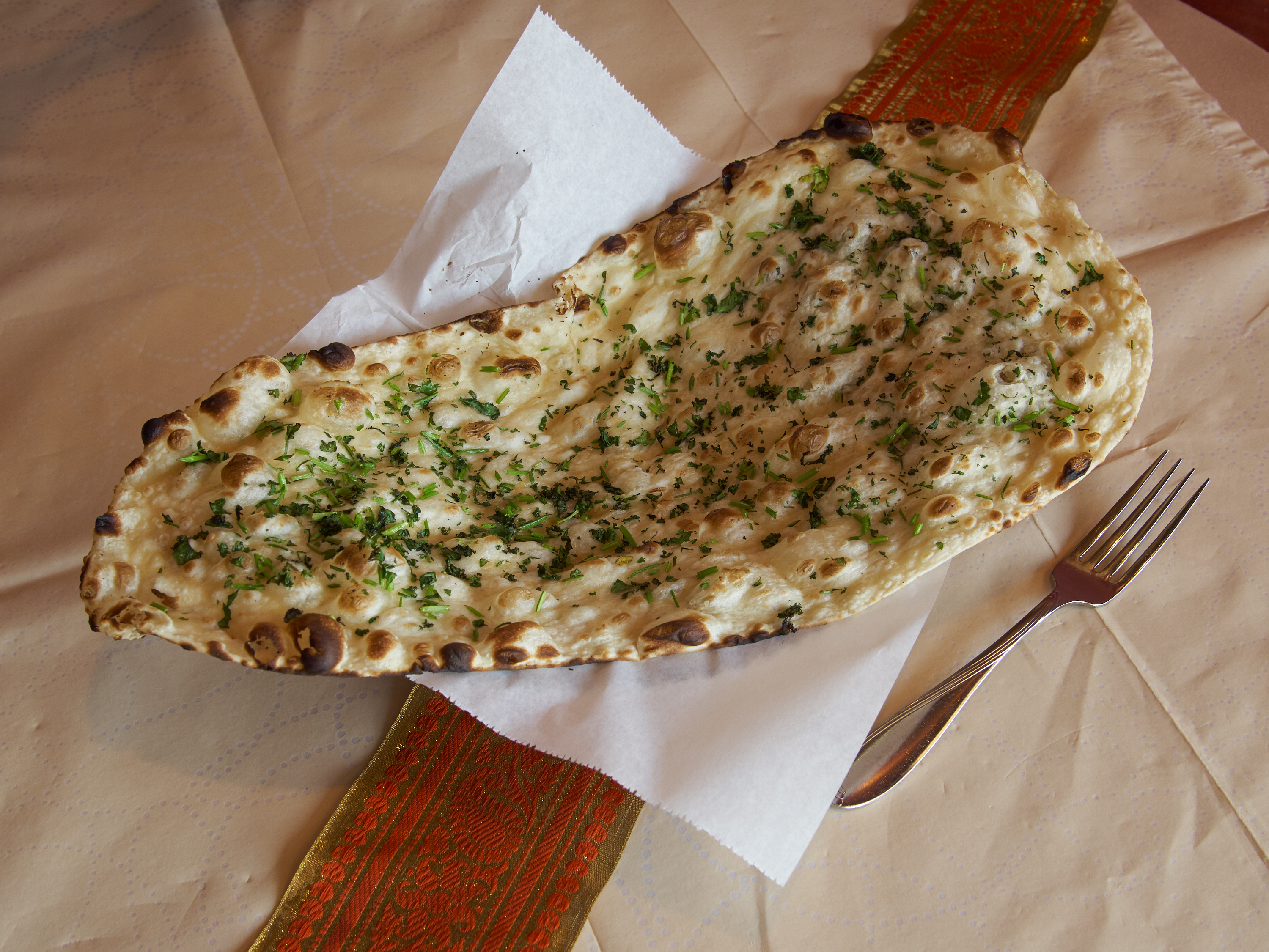 Order Garlic Naan food online from New Delhi Palace store, Tucson on bringmethat.com