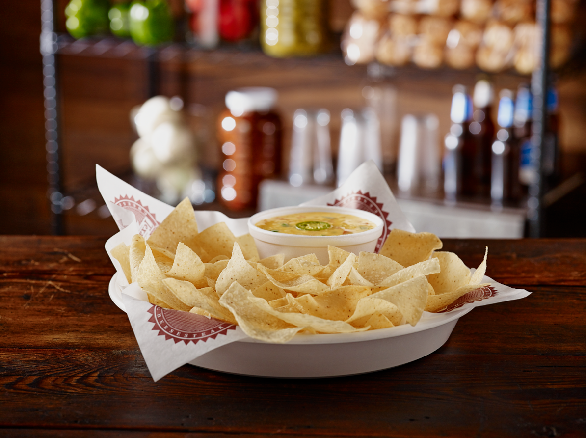 Order Fresh Tortilla Chips with Housemade Queso food online from Texadelphia store, San Antonio on bringmethat.com