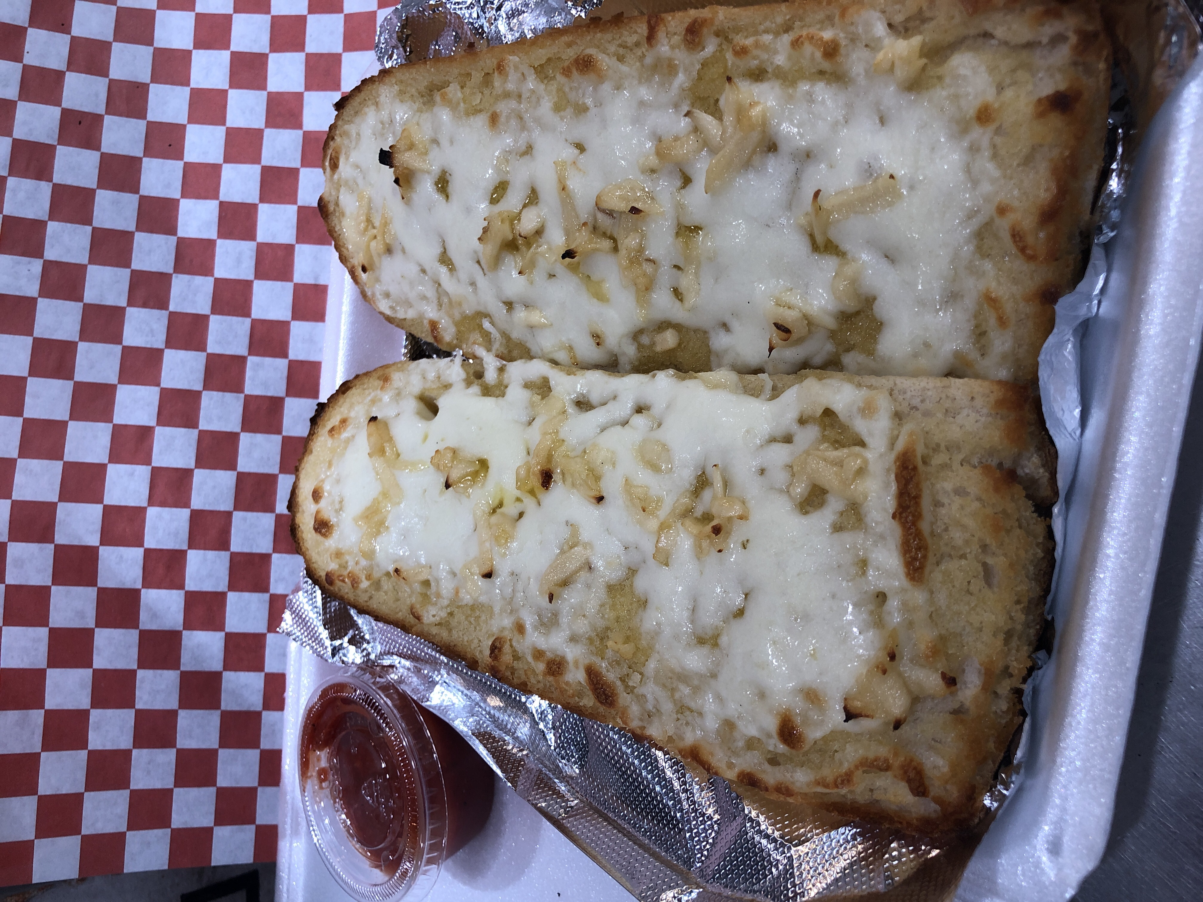 Order Garlic Bread with Melted Cheese food online from Milan Pizzeria store, Royal Oak on bringmethat.com