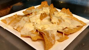 Order 76. Nachos with Cheese food online from La Tolteca store, Williamsburg on bringmethat.com
