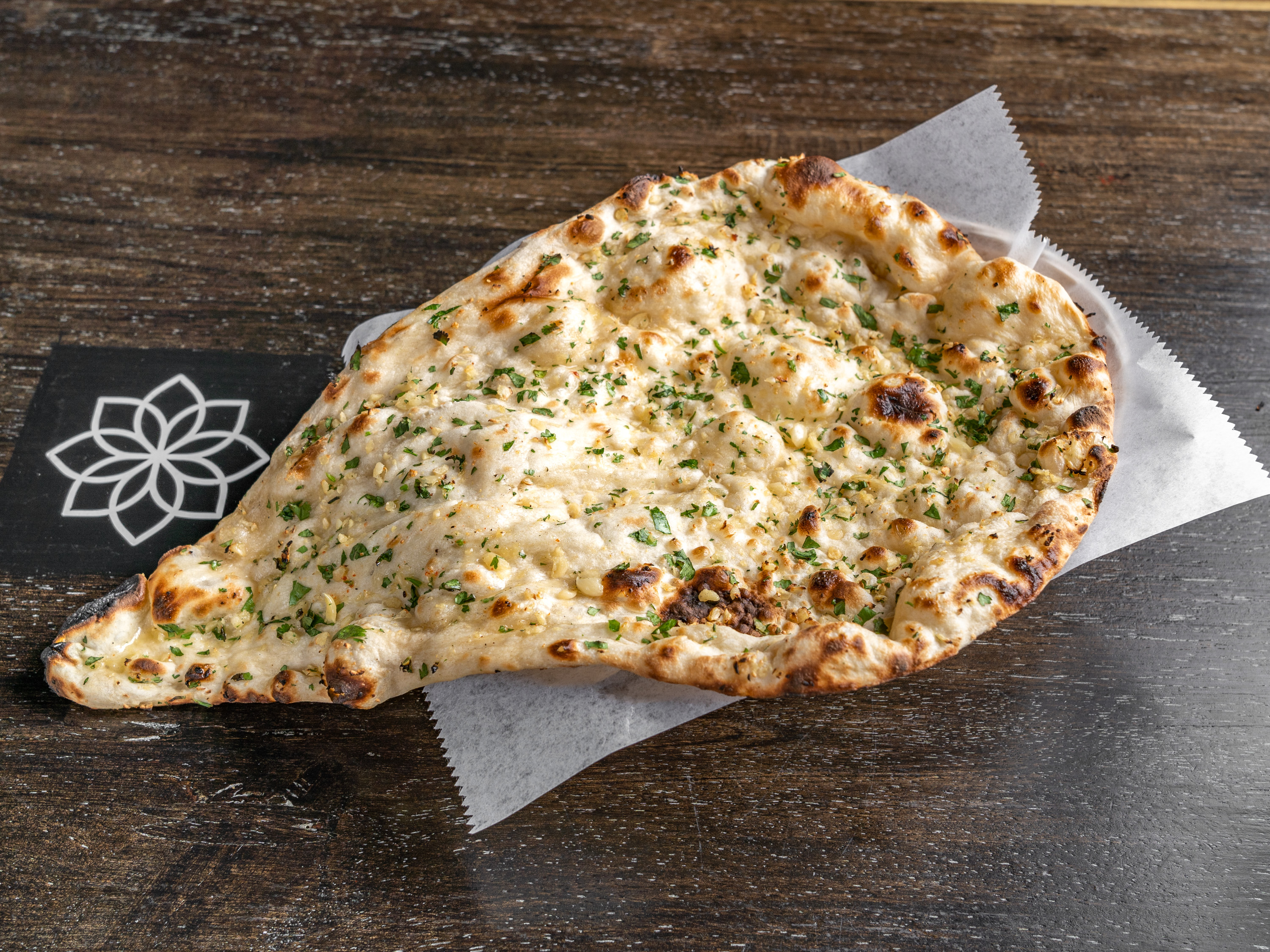 Order Garlic Naan food online from The Writing Room store, New York on bringmethat.com