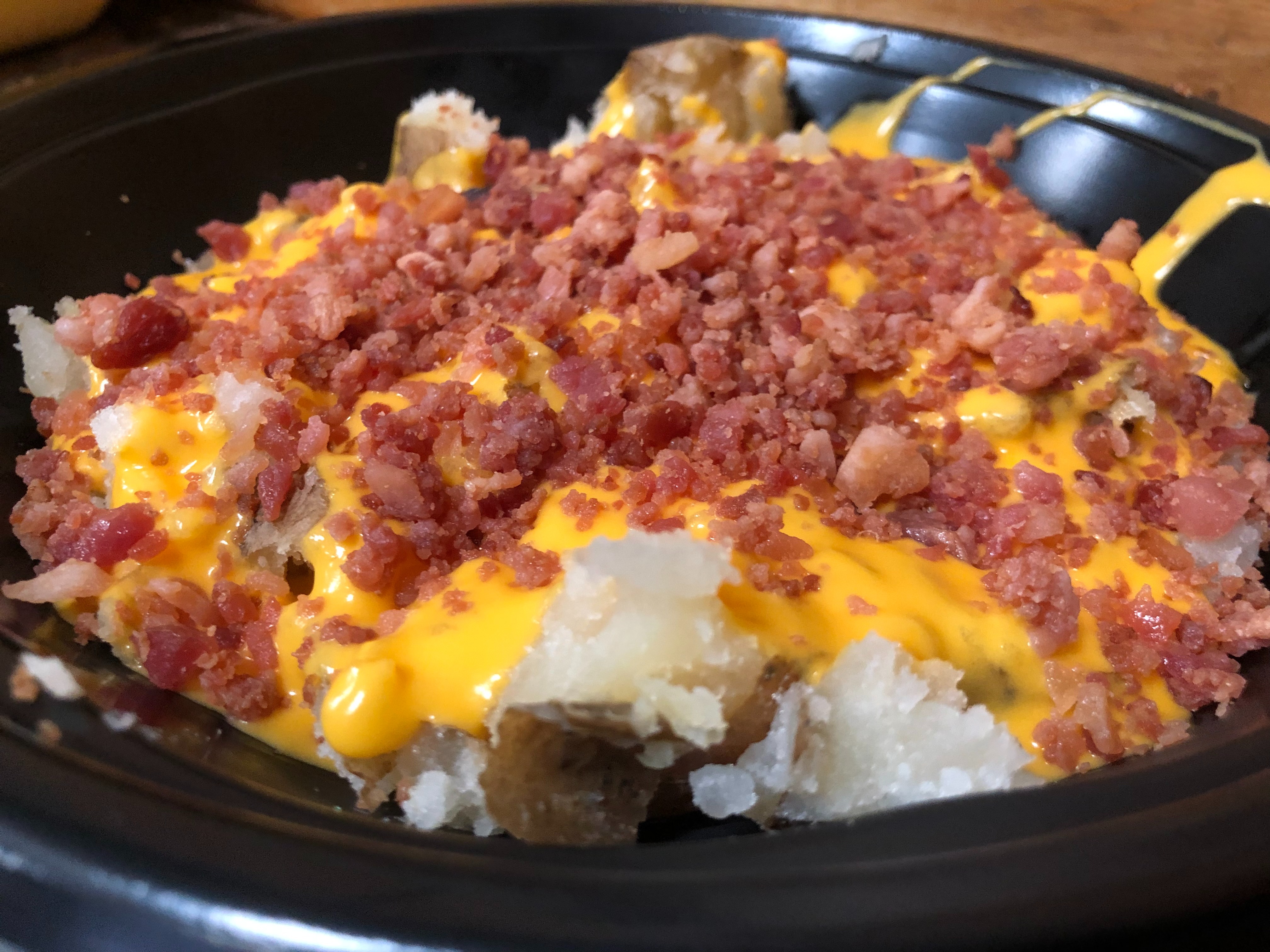 Order 25. Melted Cheddar Cheese & Bacon Bits Potato food online from Lieber Boxcar Express store, Galesburg on bringmethat.com