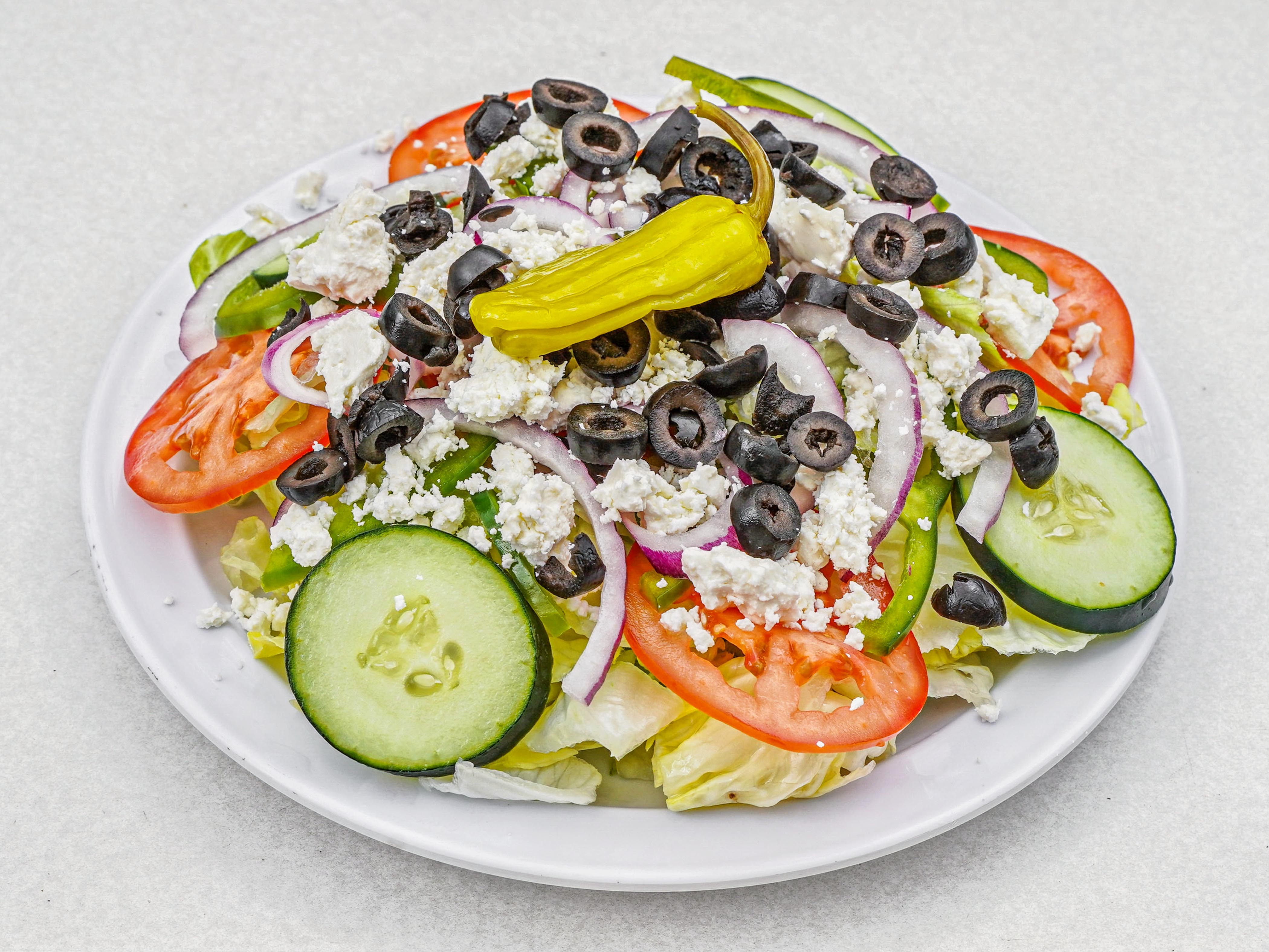 Order Greek Salad food online from Peppoli Pizza & Philly Steak store, San Diego on bringmethat.com