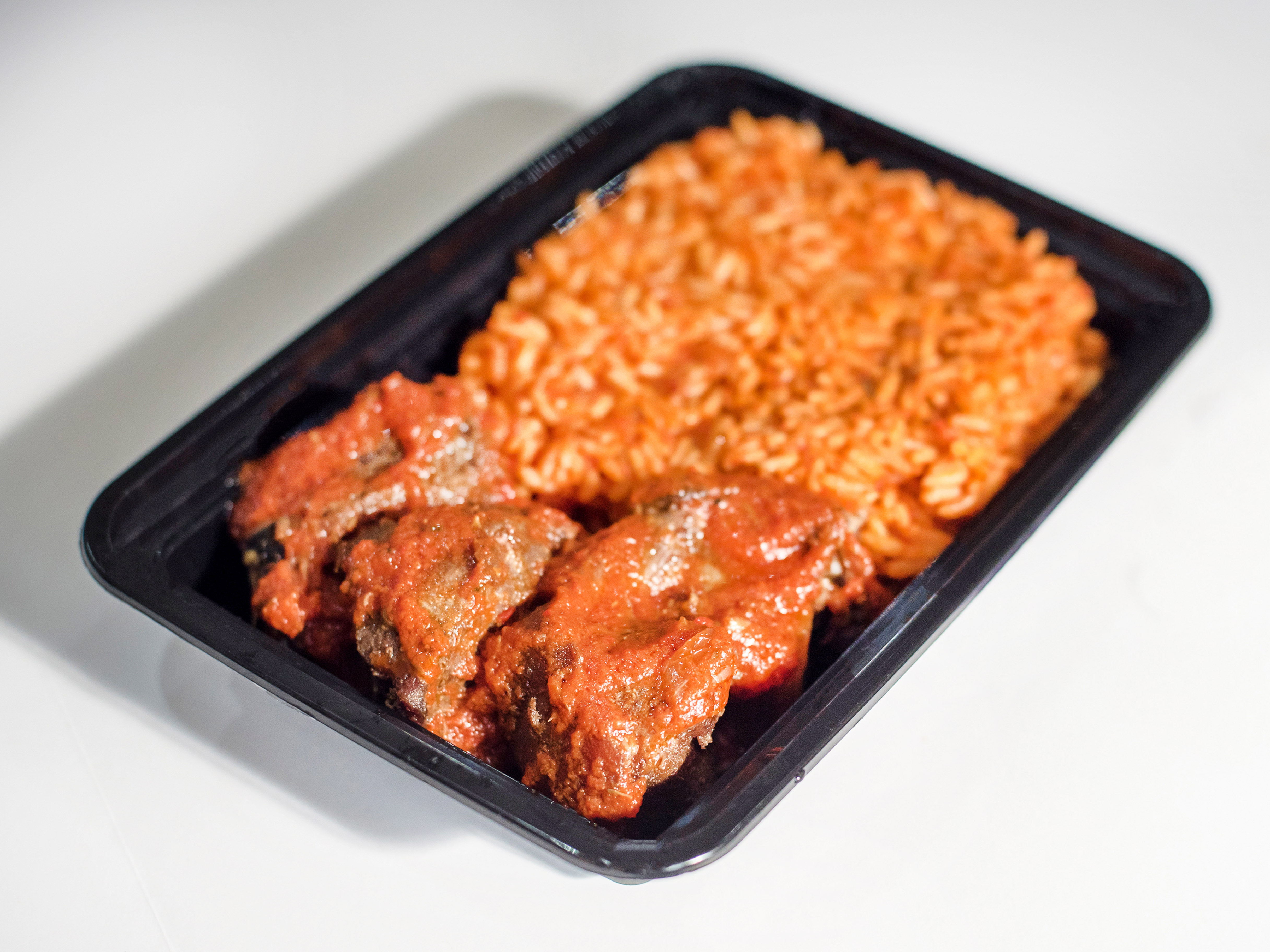 Order Goat Meat and Jollof Rice food online from African Caribbean Food Market store, Oakland on bringmethat.com