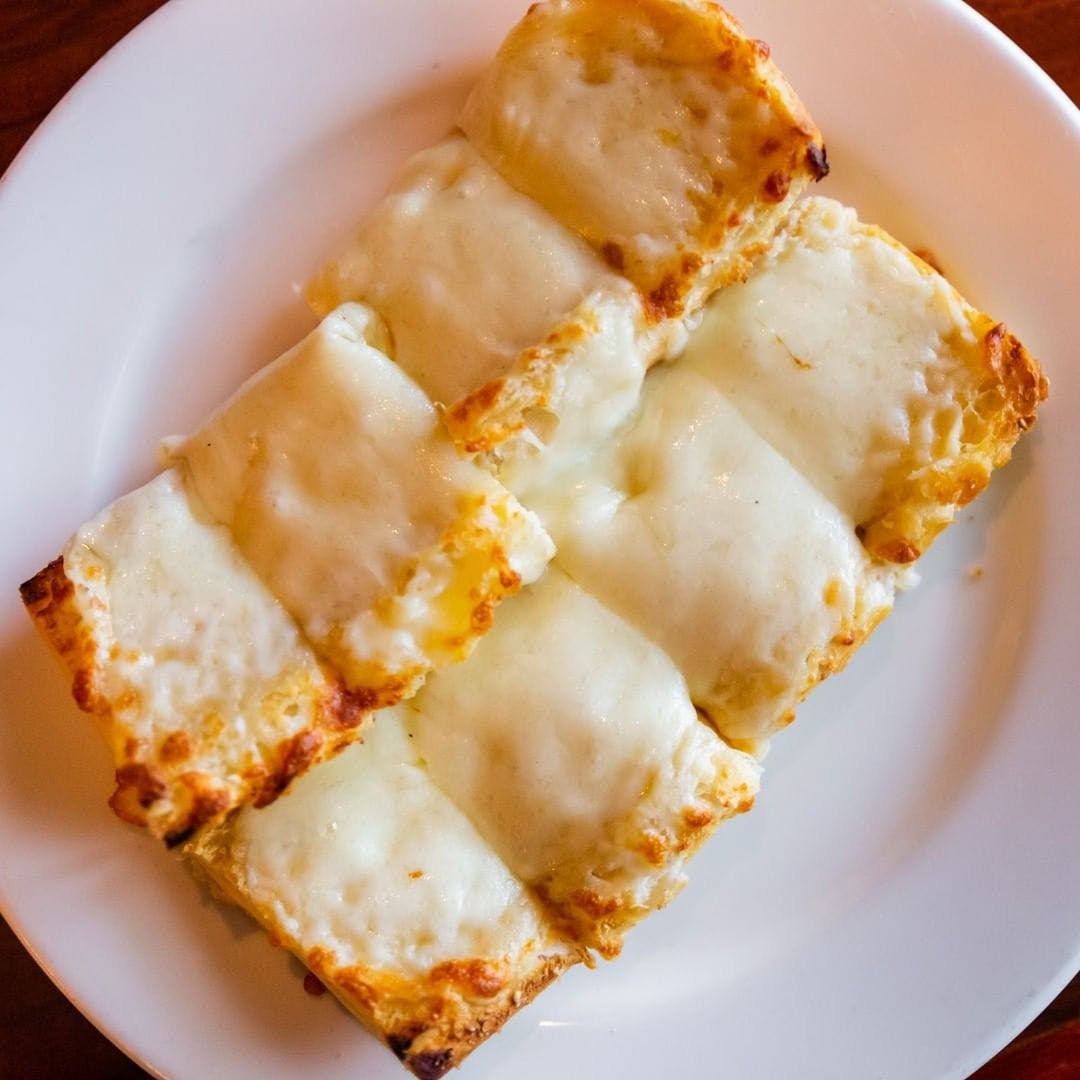 Order Garlic Bread with Cheese - Appetizer food online from Michael's Italian Restaurant store, Waukesha on bringmethat.com