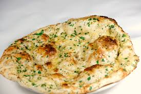 Order Garlic Naan food online from The indian kitchen store, West Hollywood on bringmethat.com
