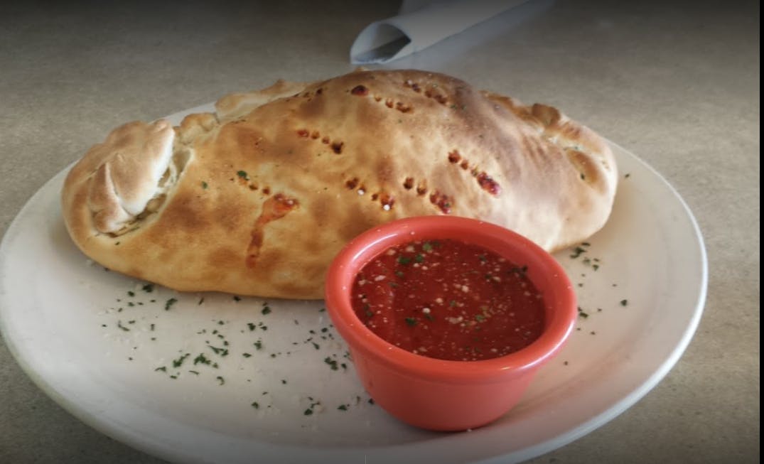 Order Veggie Calzone - Calzone food online from Saucy's Pizza store, Littleton on bringmethat.com