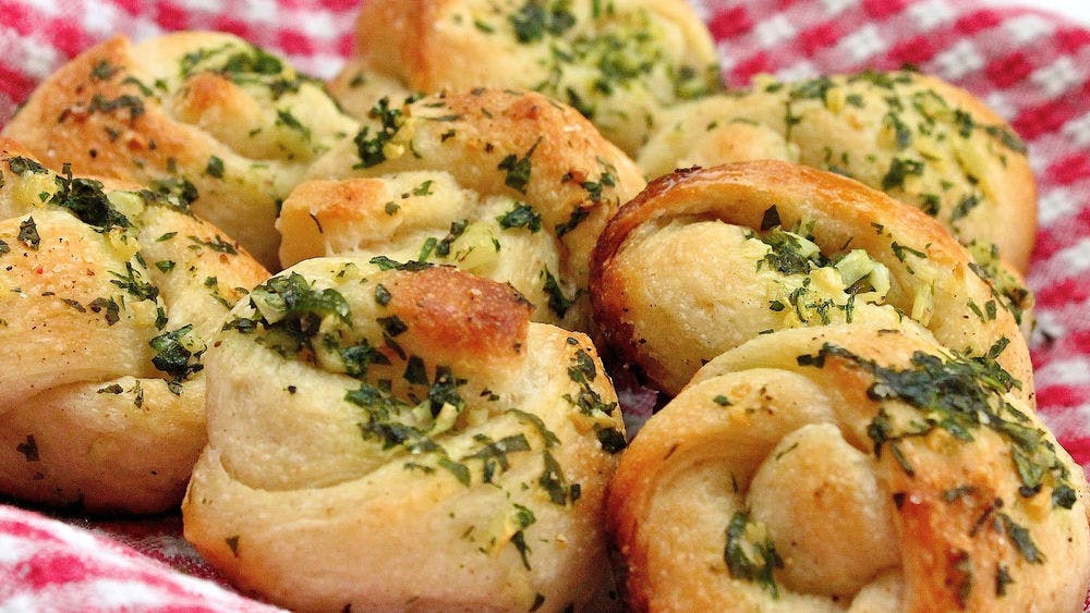 Order Garlic Knots with Cheese - 5 Pieces food online from Giardino Pizzeria & Restaurant store, Glade Spring on bringmethat.com