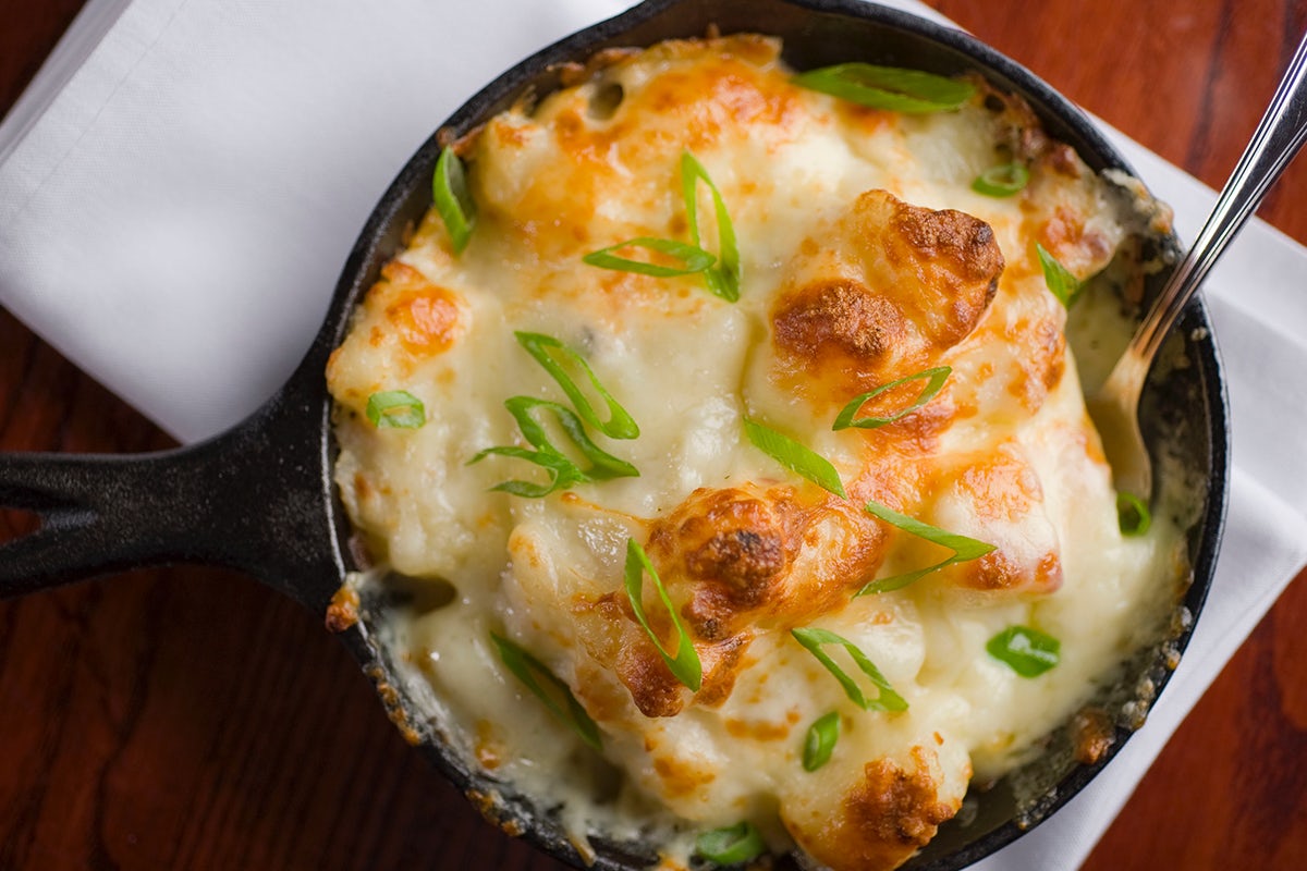 Order WHITE CHEDDAR & BACON AU GRATIN POTATOES food online from Sullivan's Steakhouse store, Omaha on bringmethat.com
