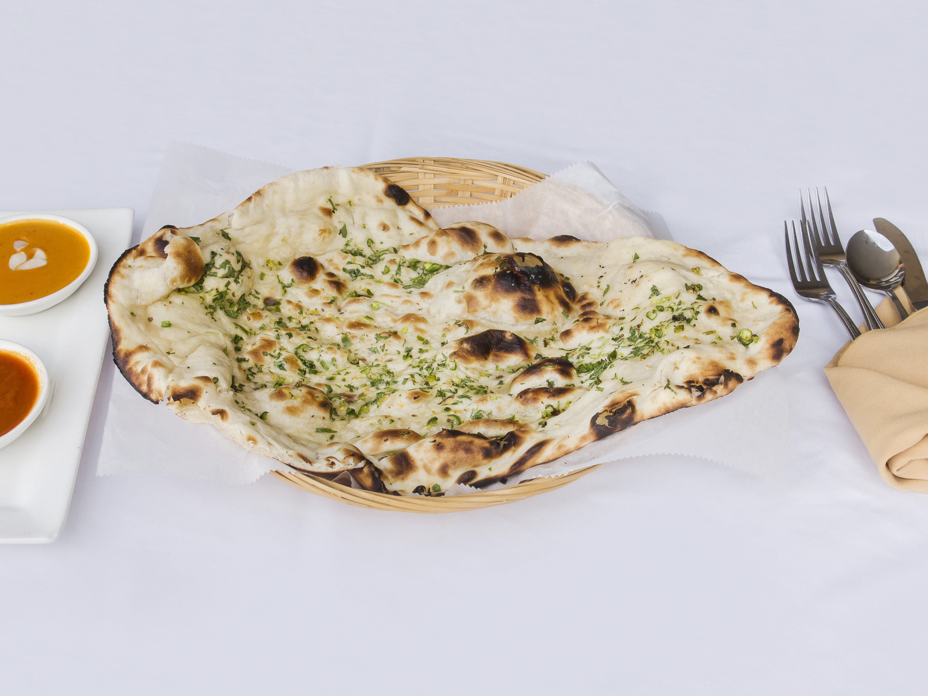 Order 80. Garlic Naan food online from Rivaaz Indian Cuisine store, Monroe Township on bringmethat.com