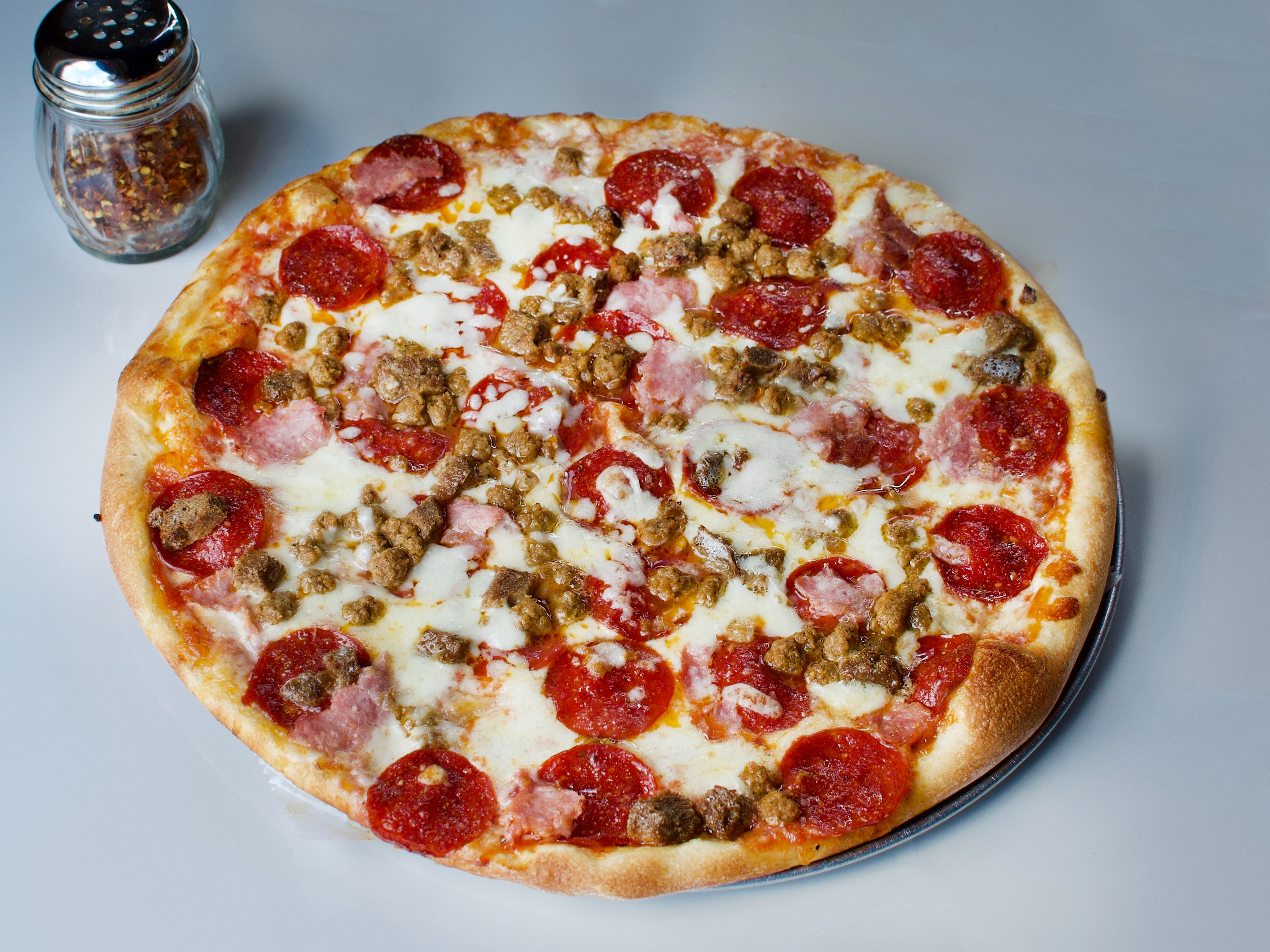 Order Meat Lovers Pizza food online from New Yorker Pizza store, Leesburg on bringmethat.com
