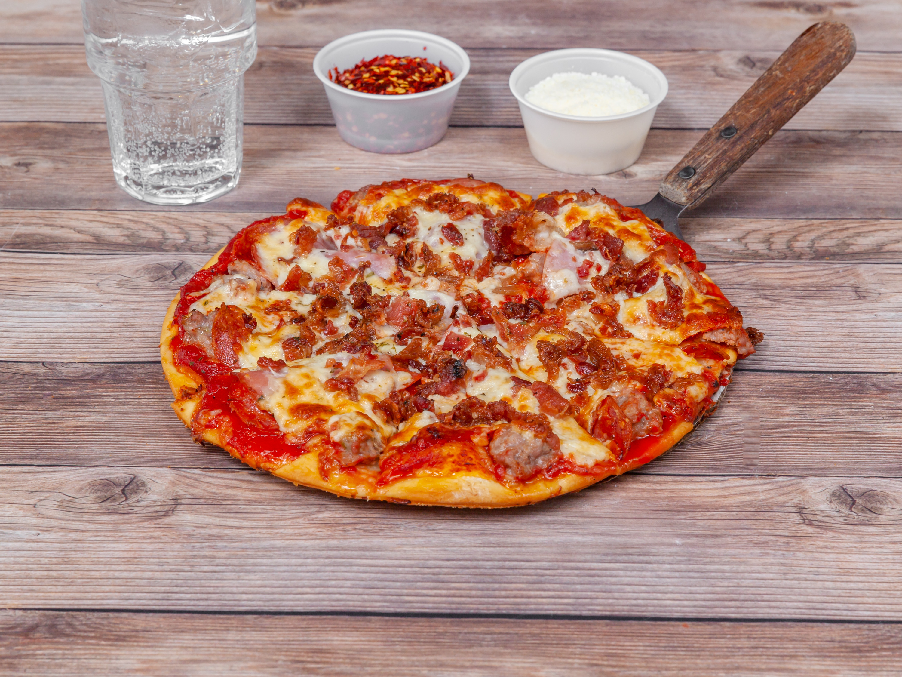 Order Meat Lovers Thin Crust Pizza food online from Village Pizza & Pub store, Carpentersville on bringmethat.com