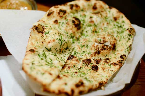 Order Garlic Naan food online from Passage To India store, Tempe on bringmethat.com