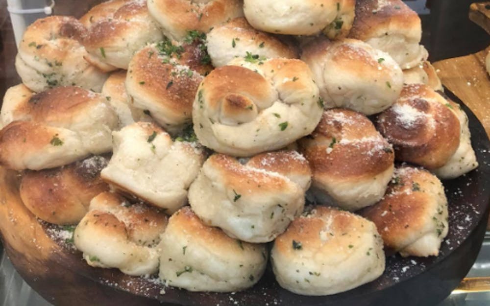 Order Garlic Knots with Sauce - 3 Pieces food online from Sicilian Delight store, Victor on bringmethat.com