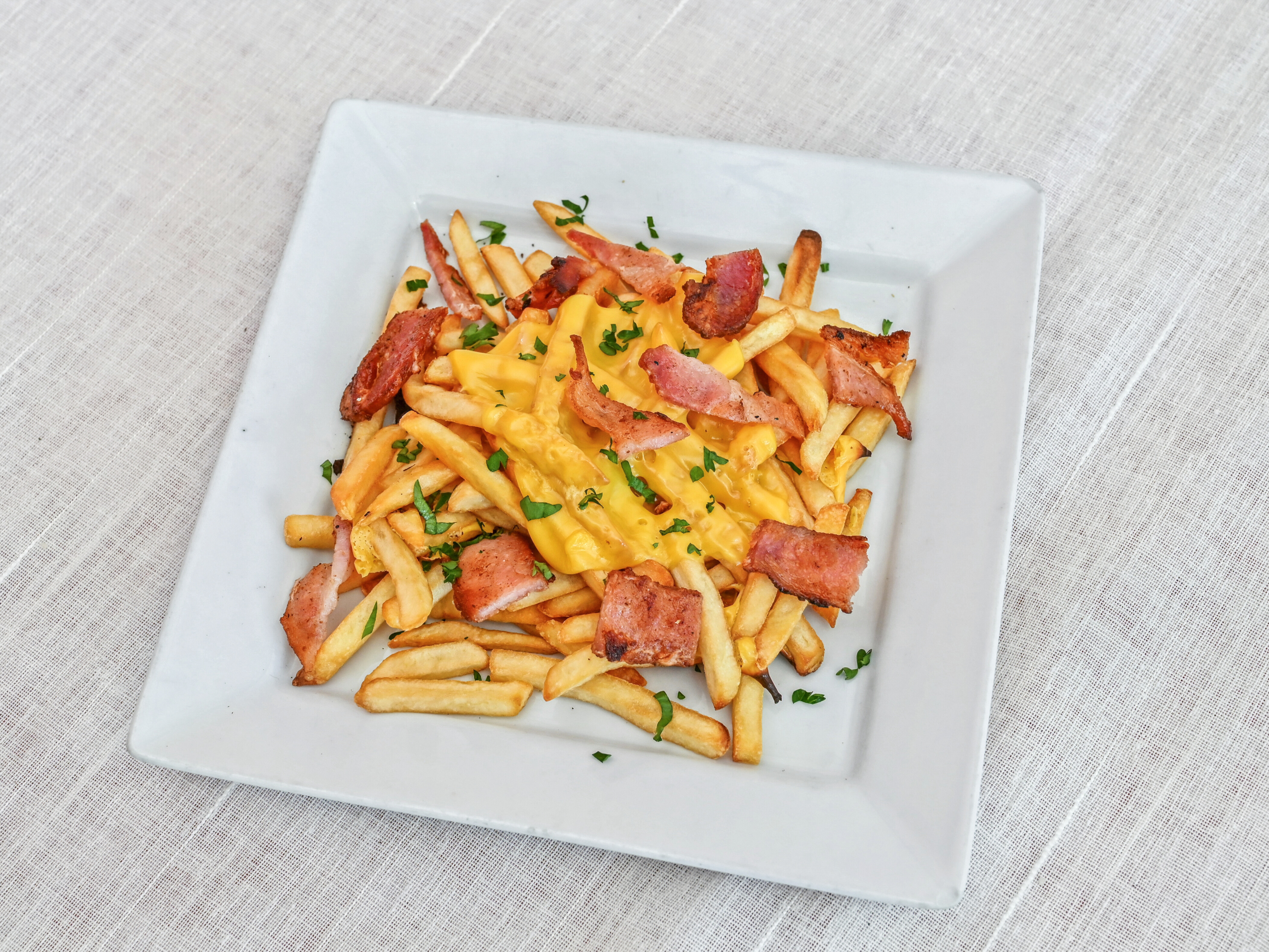 Order French Fries with Bacon & Cheese food online from Mona Lisa Pizzeria & Sub Shop store, Coral Gables on bringmethat.com