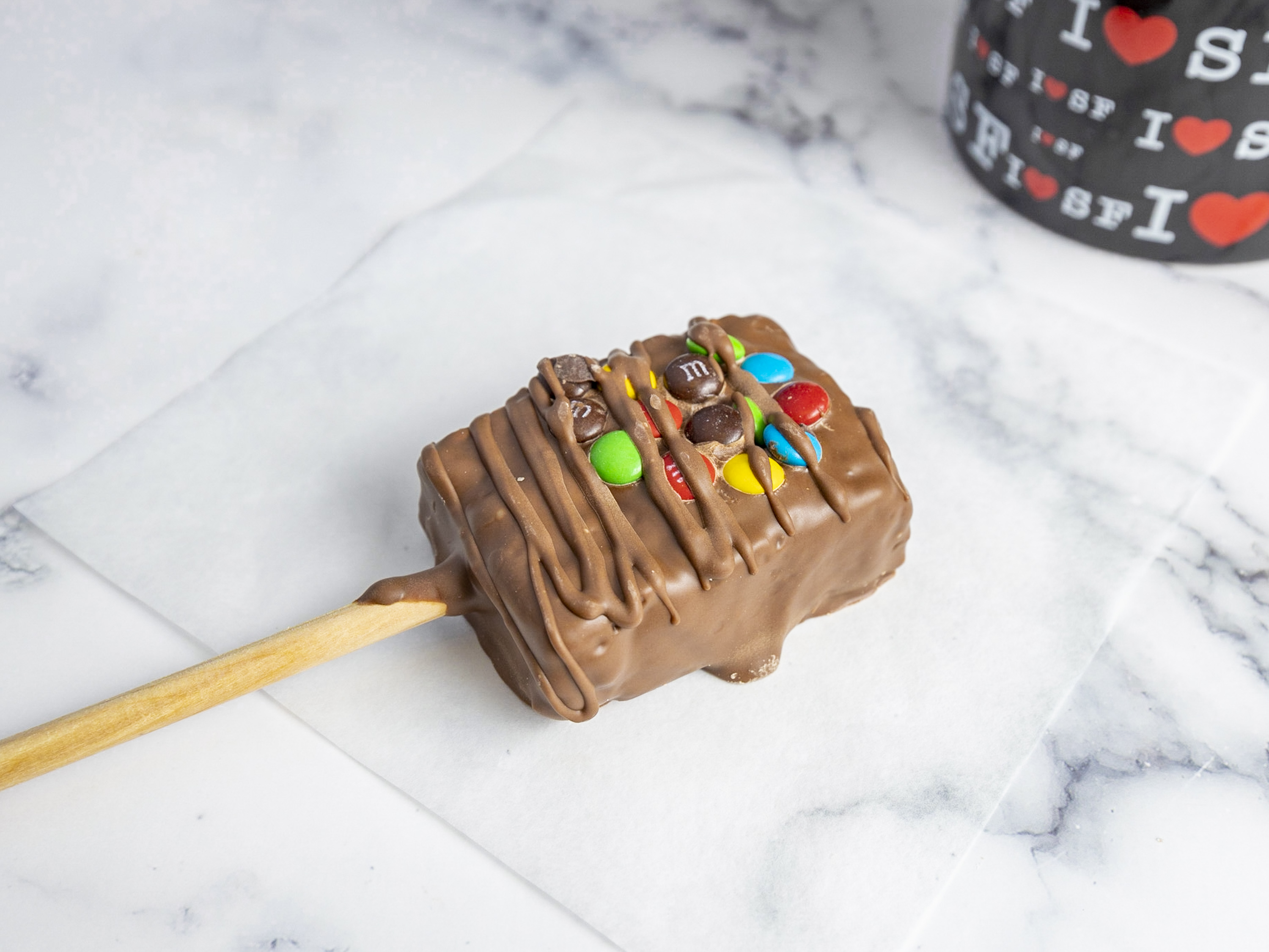 Order Chocolate Dipped Rice Krispy Treat on a Stick with M and M’s food online from San Francisco Chocolate Store store, San Francisco on bringmethat.com