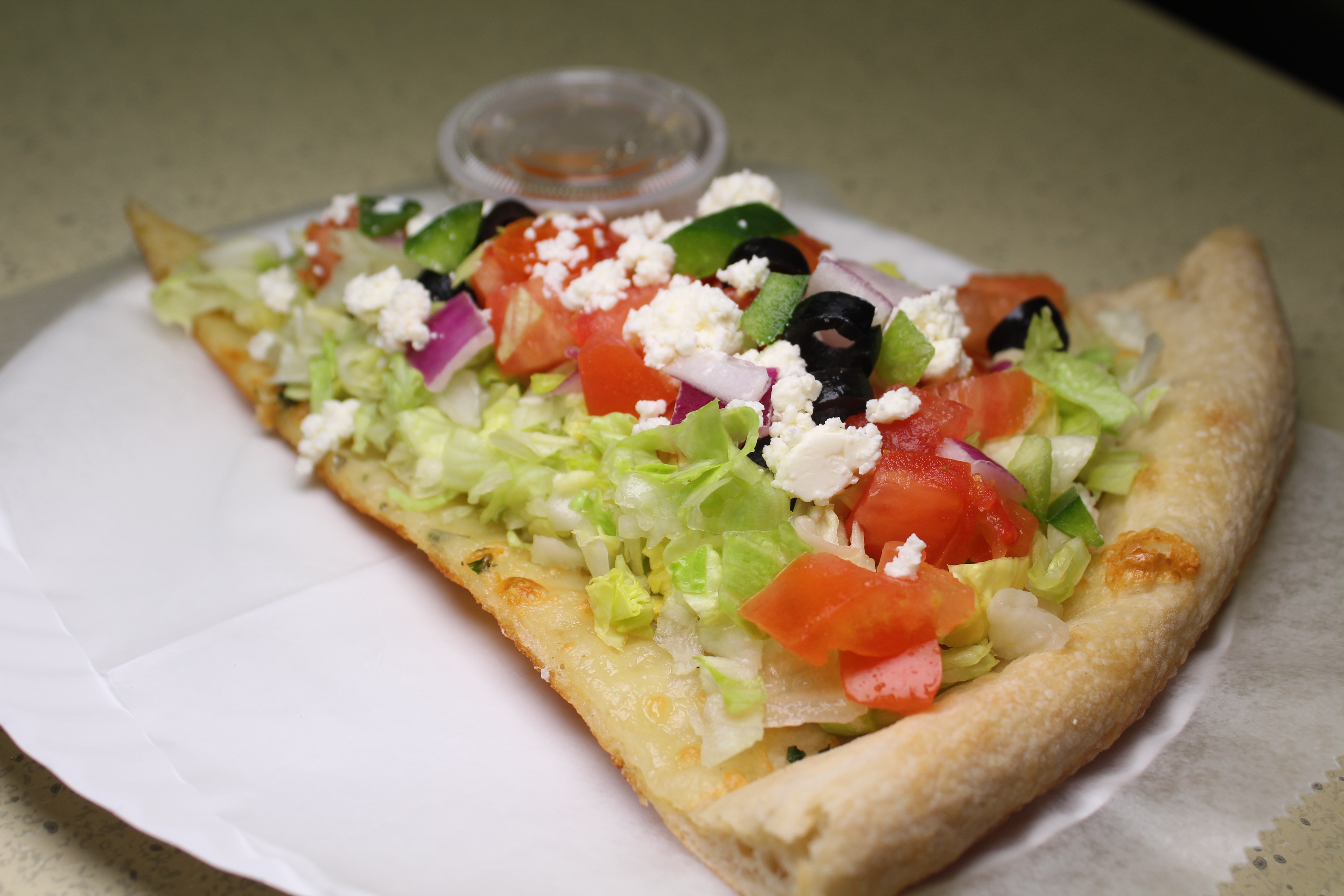 Order Greek Salad Slice food online from Pizzaiola store, North Babylon on bringmethat.com