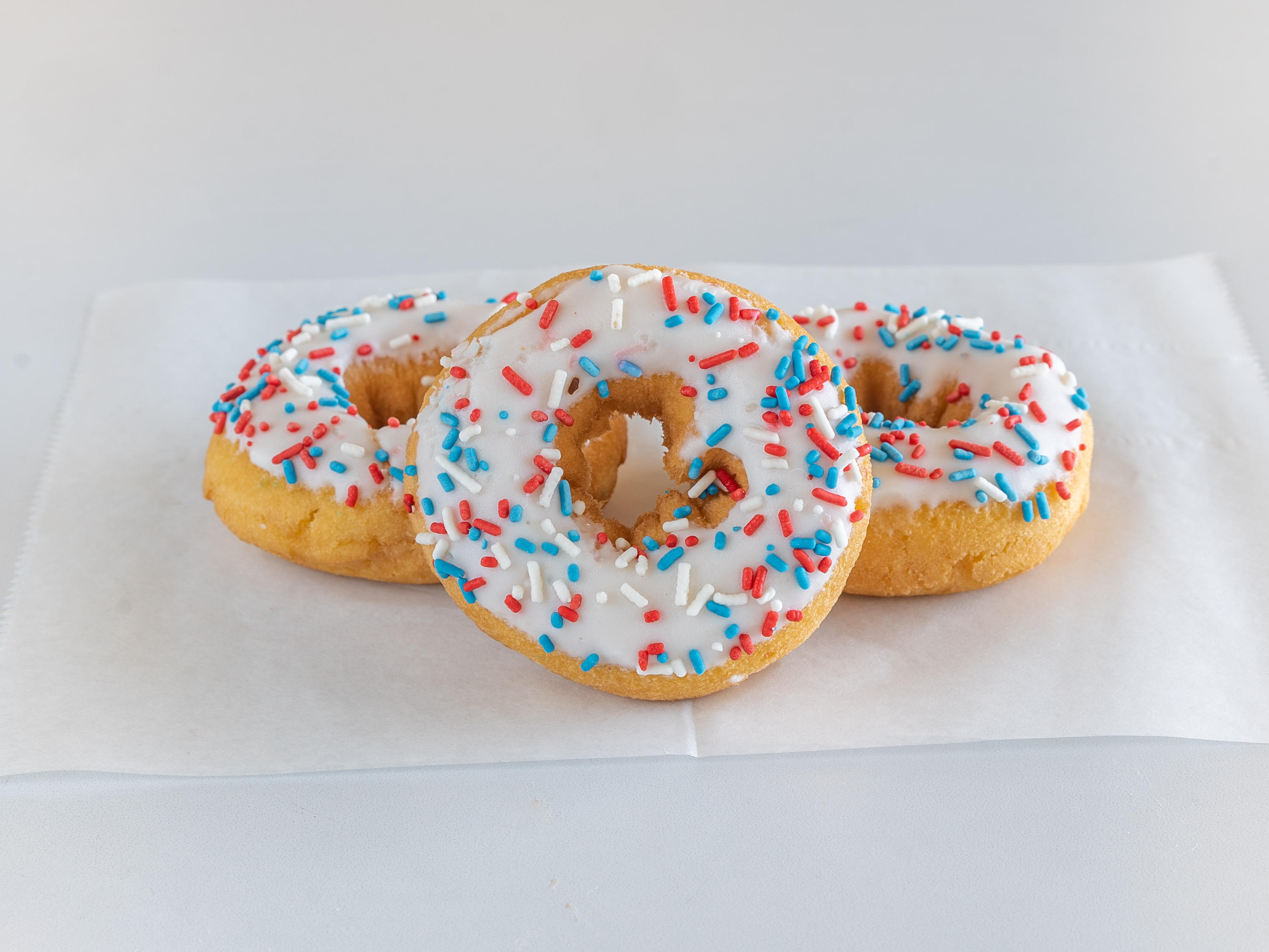 Order Vanilla Iced Raised Donut with Sprinkles food online from Mary Ann Donuts store, North Canton on bringmethat.com