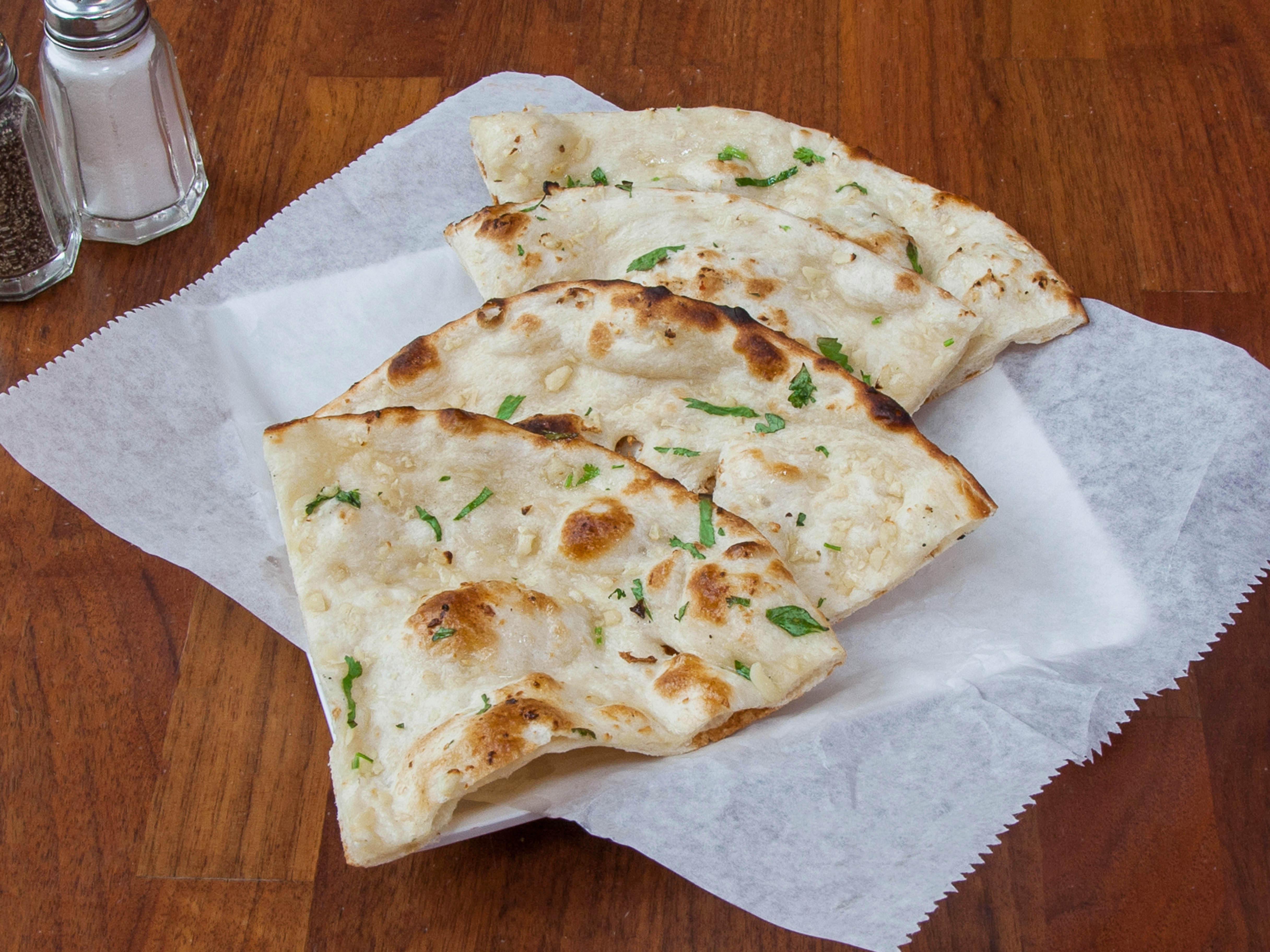 Order Butter Garlic naan food online from Chicago Hot Breads store, Naperville on bringmethat.com