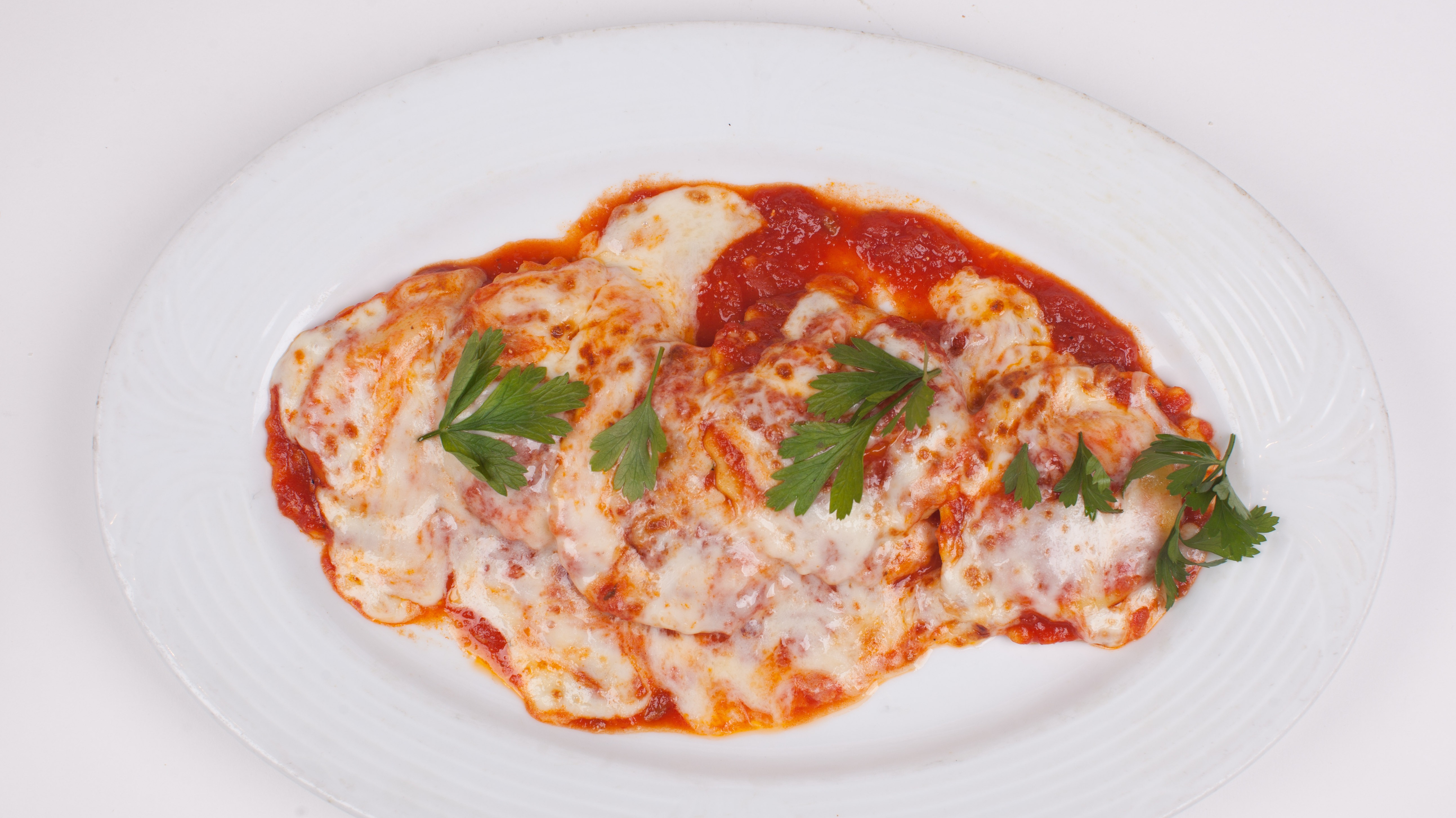 Order Baked Cheese Ravioli food online from Umberto's Pizzeria store, New Hyde Park on bringmethat.com