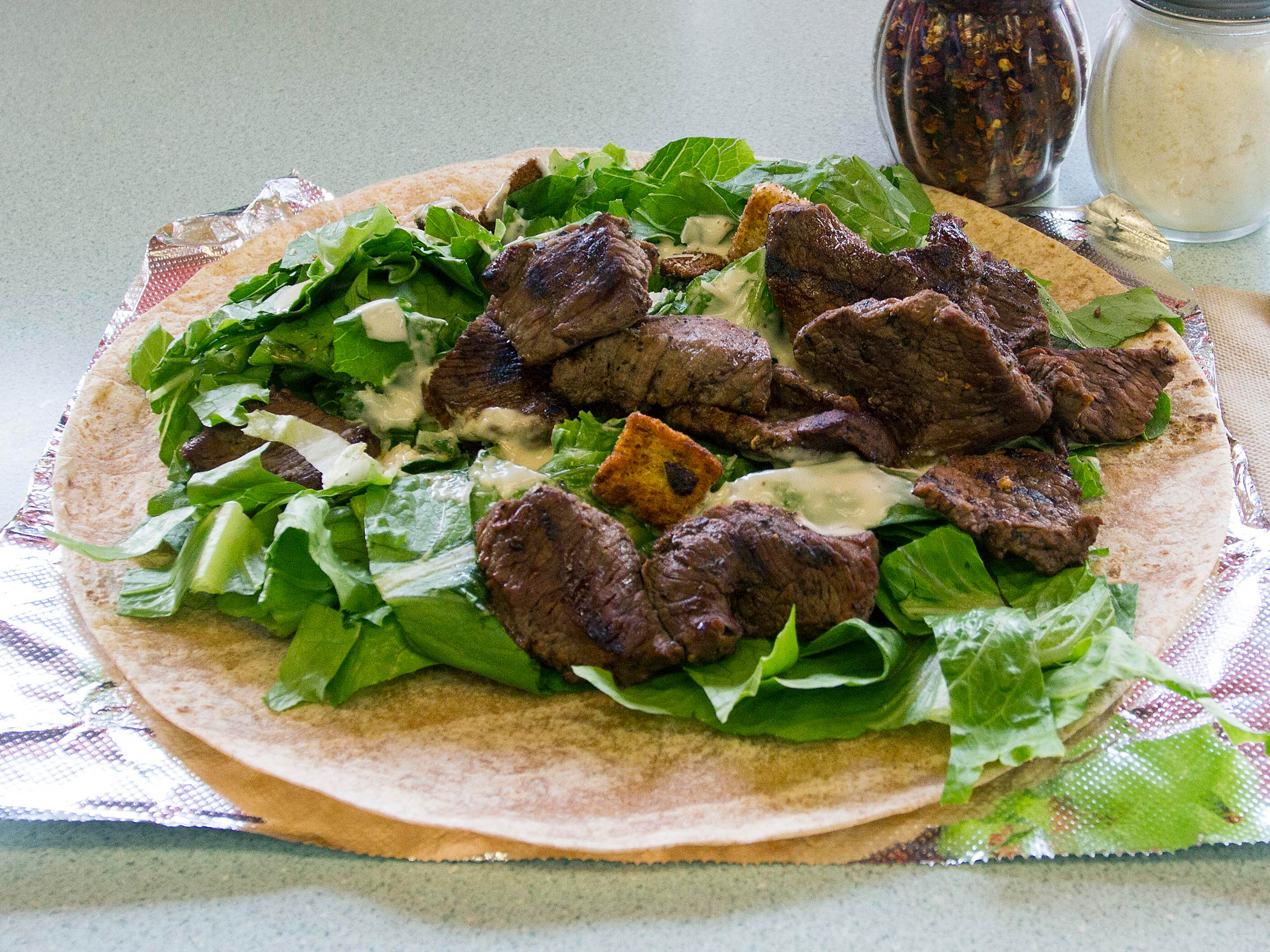 Order Sirloin Steak Tip Caesar Wrap food online from Village Pizza & Grill store, South Boston on bringmethat.com