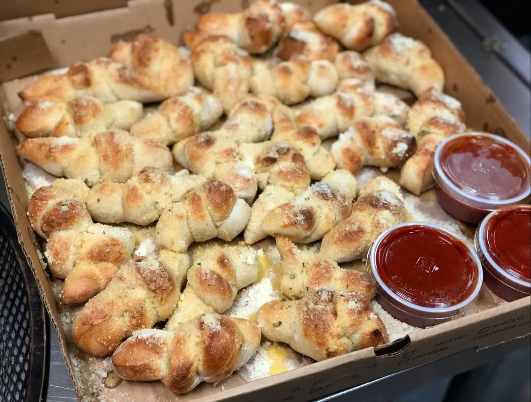 Order Garlic Knots with Marinara Sauce - 6 Pieces food online from Giuseppe's Pizza Shop store, Plattsburgh on bringmethat.com