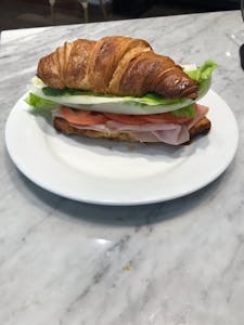Order PARIS CROISSANT: Ham, Bacon, Brie, Avocado, Lettuce, Tomato food online from Milano Cafe & Deli store, Burbank on bringmethat.com