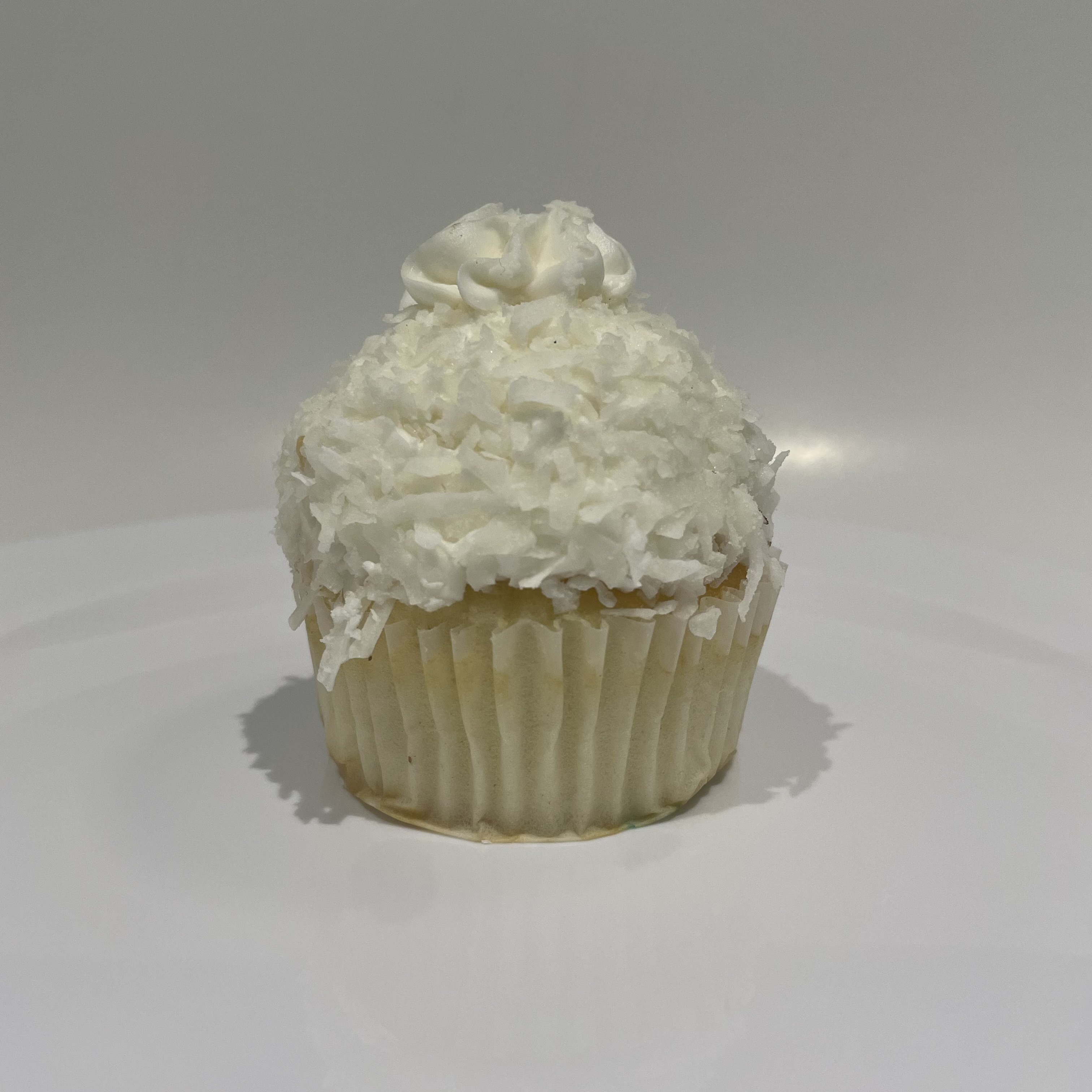 Order Vanilla Coconut Snowball Cupcake food online from The House of Cupcakes store, Princeton on bringmethat.com