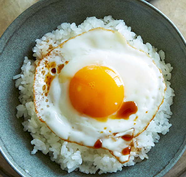 Order Sunny Side up egg over rice food online from Peachtree Neighborhood Grill store, Nashville on bringmethat.com