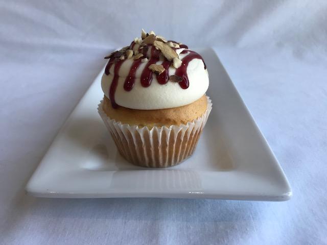 Order Almond Raspberry Cream Cupcake food online from The Sweet Spot Bakery store, Fort Worth on bringmethat.com