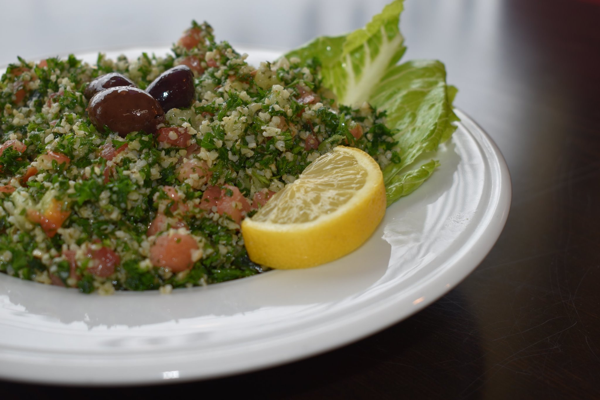Order Tabouli Salad food online from Omar Pizza & Mediterranean Grill store, Fairview Park on bringmethat.com