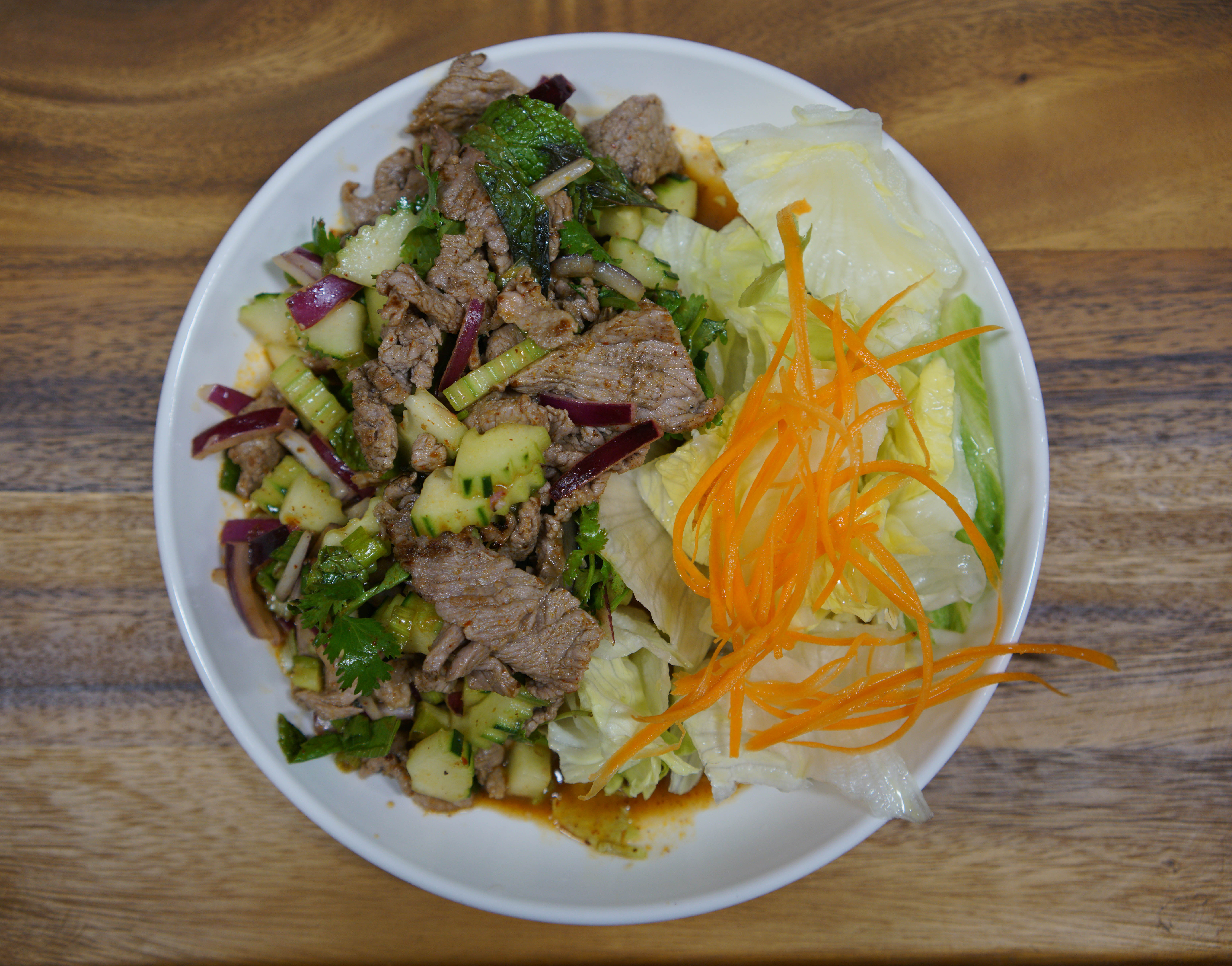 Order SPICY BEEF SALAD (YUM NEAU) food online from Coco Thai Kitchen store, Los Angeles on bringmethat.com
