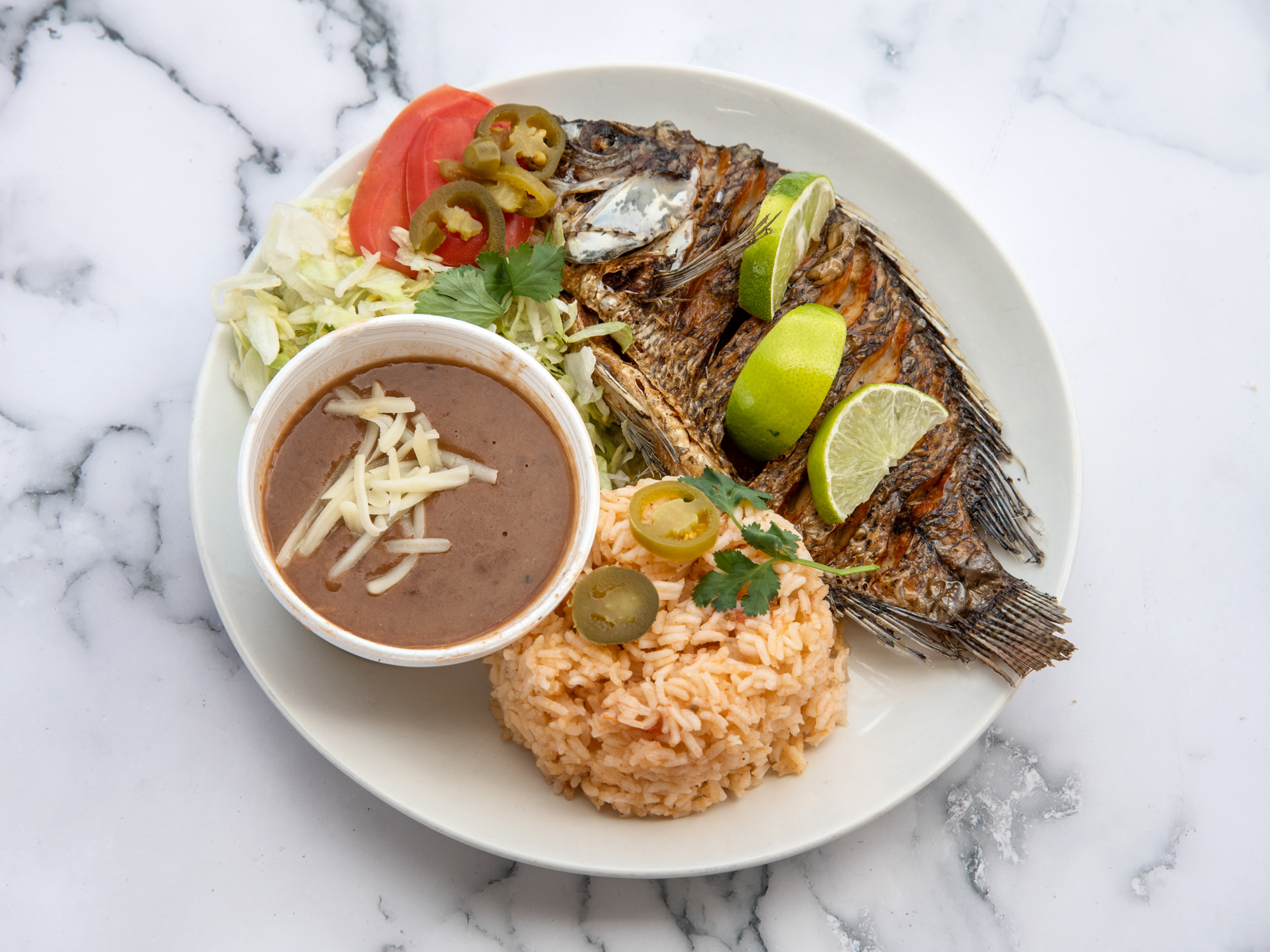 Order Fried Tilapia Plate with Rice and Bean food online from Taco Loco store, Marietta on bringmethat.com