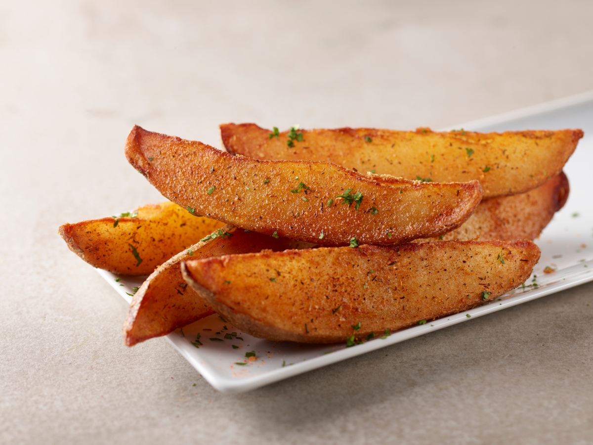 Order Potato Wedges food online from Smokey Bones Barbecue & Grill store, Lithonia on bringmethat.com