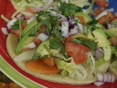 Order 1 Avocado Soft Taco, tomato, cilantro, red onion, side Tomatillo sauce food online from Tacos And Wings store, Sunland on bringmethat.com