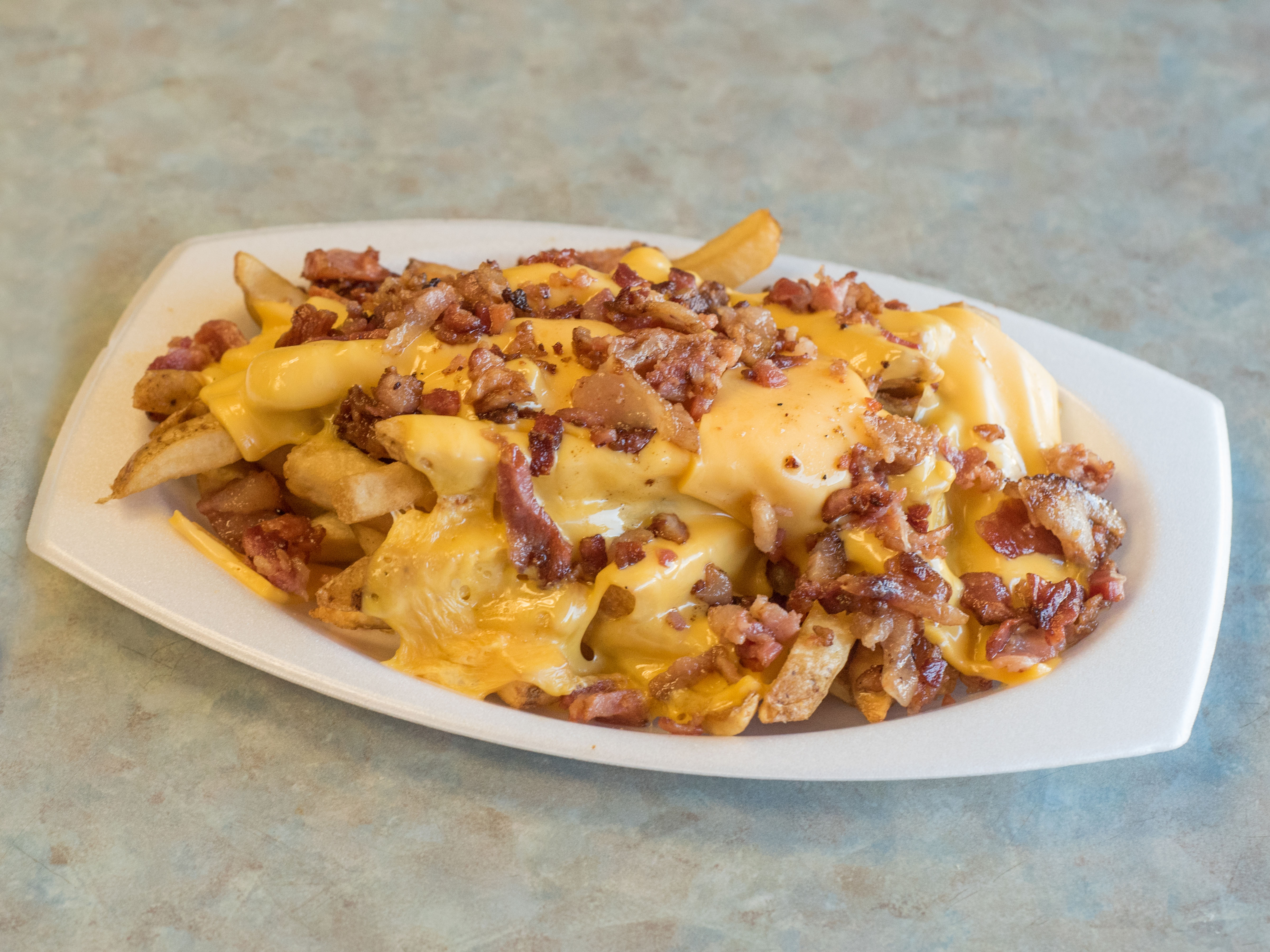 Order French Fries with Cheese and Bacon food online from Maria D's Sub Shop store, Baltimore on bringmethat.com