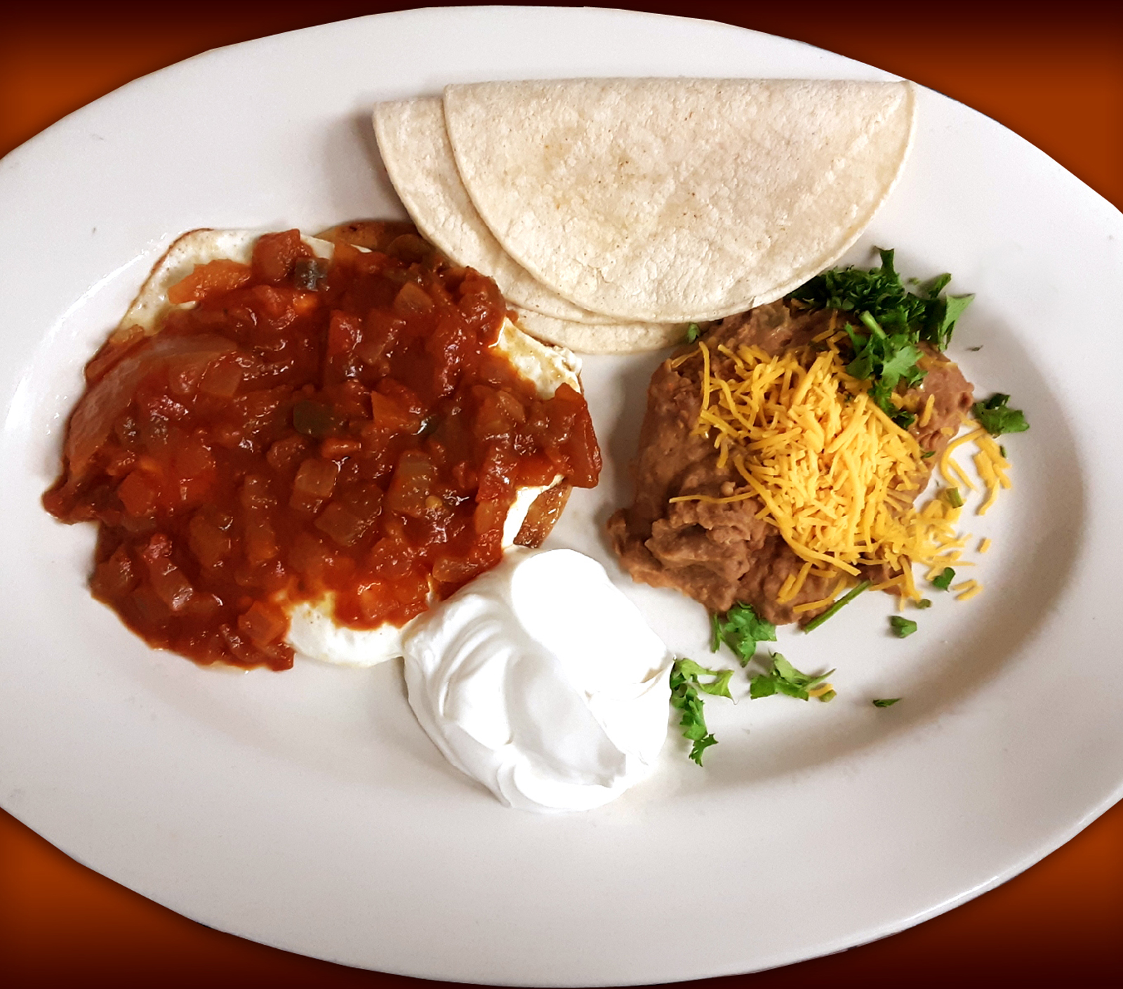 Order Huevos Rancheros food online from Pinocchio In The Desert store, Palm Springs on bringmethat.com