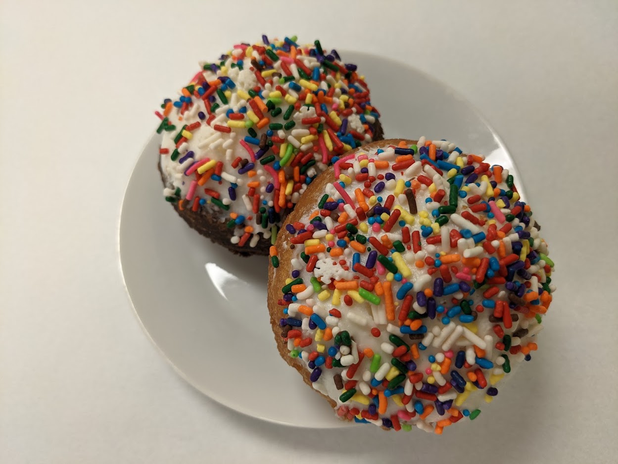 Order Yellow Cake Donut with Yummy Whip Topping and Sprinkles food online from Morkes Chocolate store, Huntley on bringmethat.com