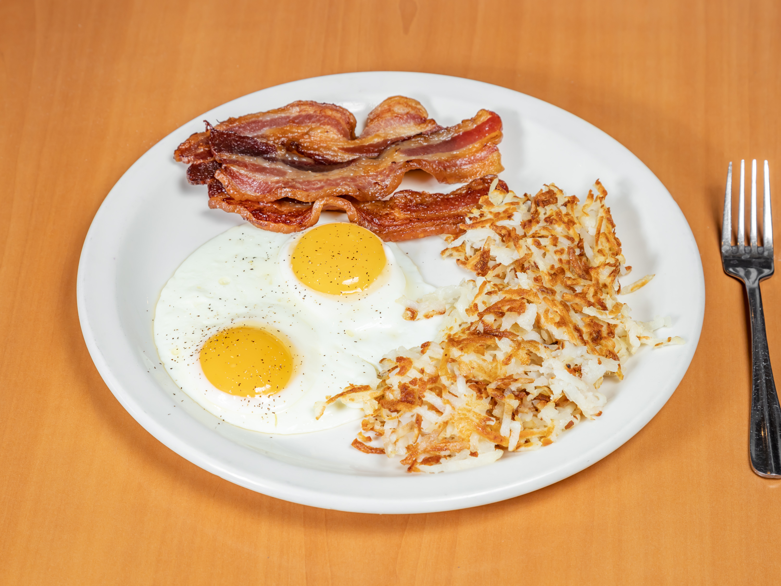 Order 2 Eggs with Canadian Bacon food online from Apple Villa Pancake House store, Batavia on bringmethat.com