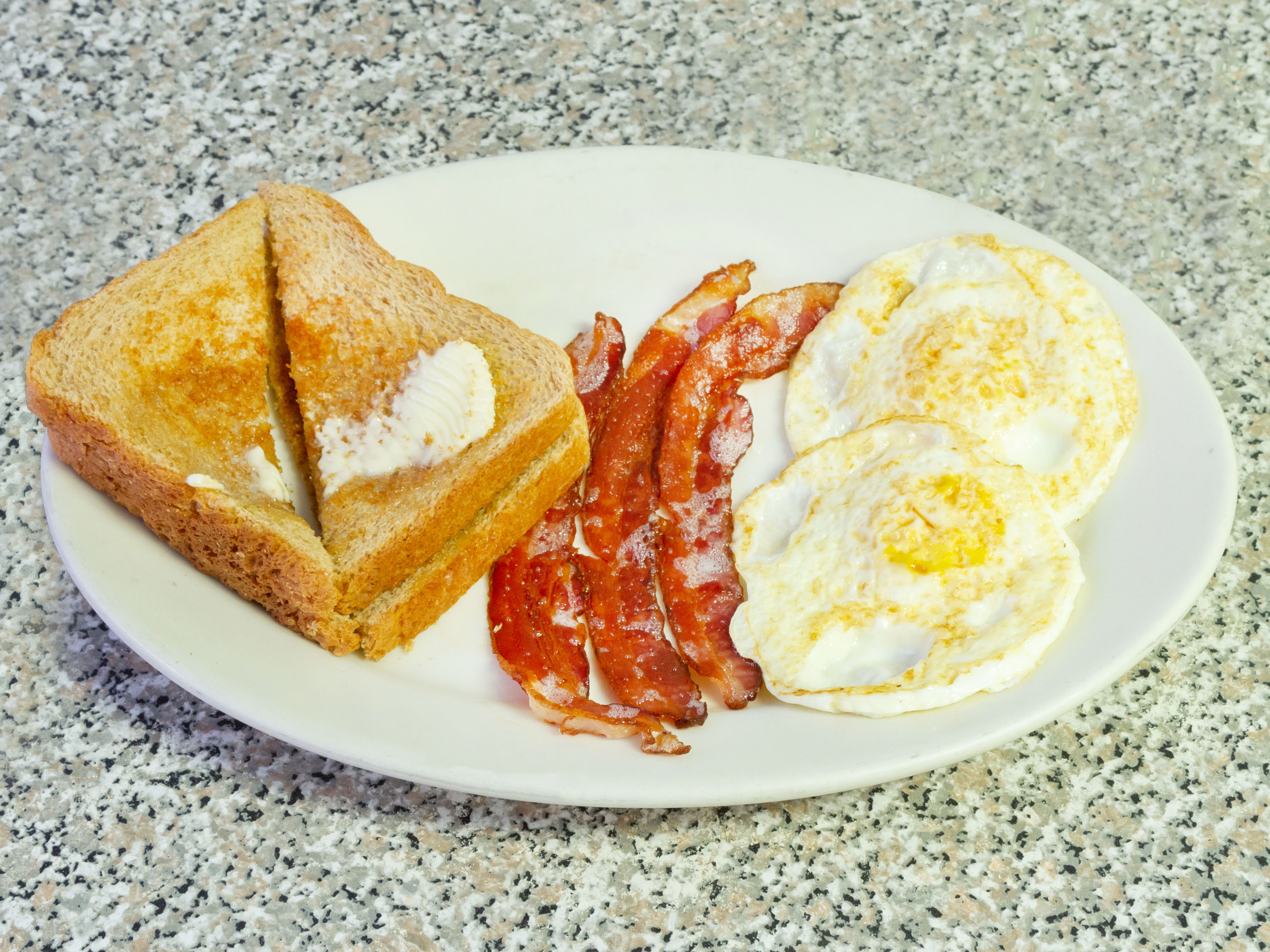 Order 2 Eggs Any Style with Toast and Bacon Combo Breakfast food online from Mangia Mangia store, Boston on bringmethat.com