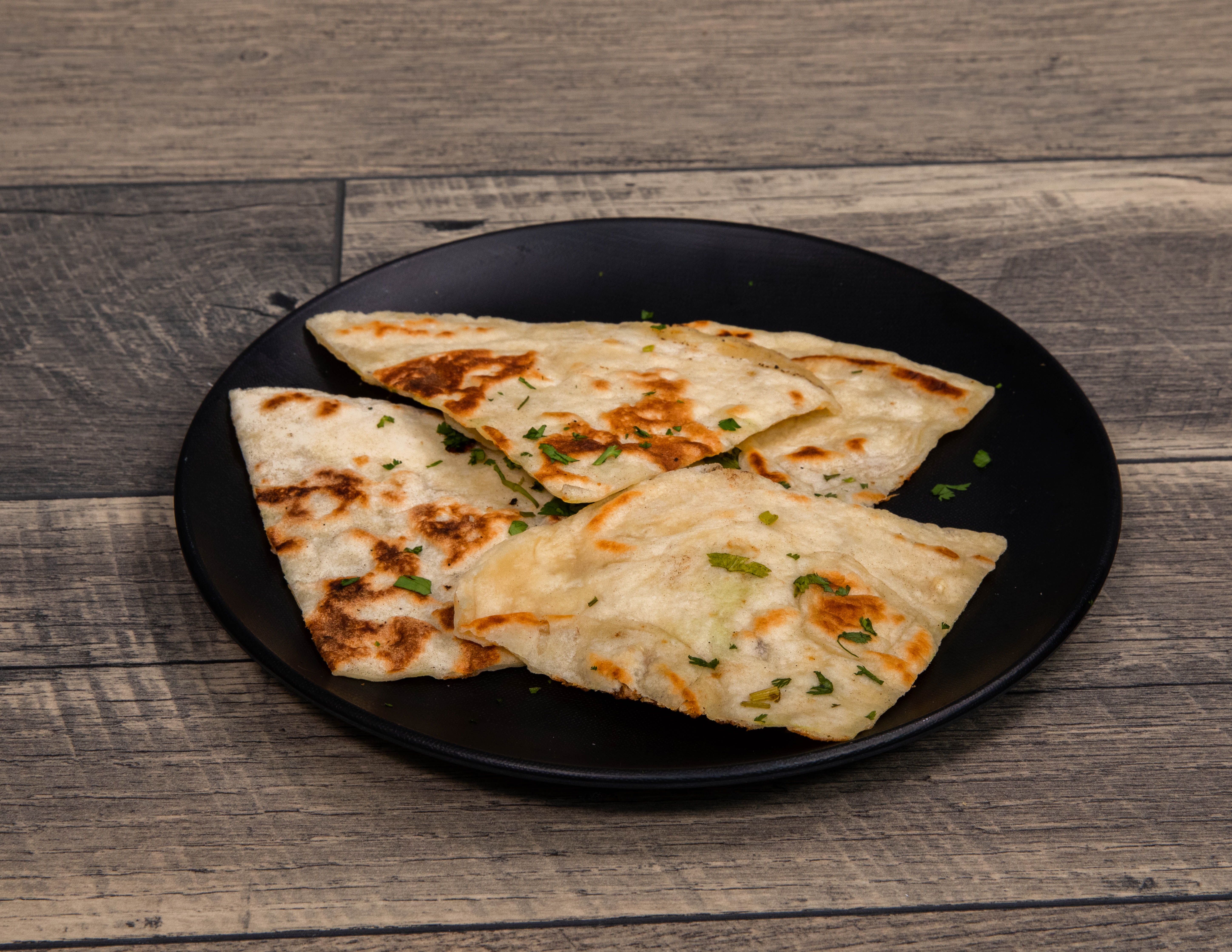 Order Garlic Naan food online from Stone Hearth Indian Cafe store, Waco on bringmethat.com