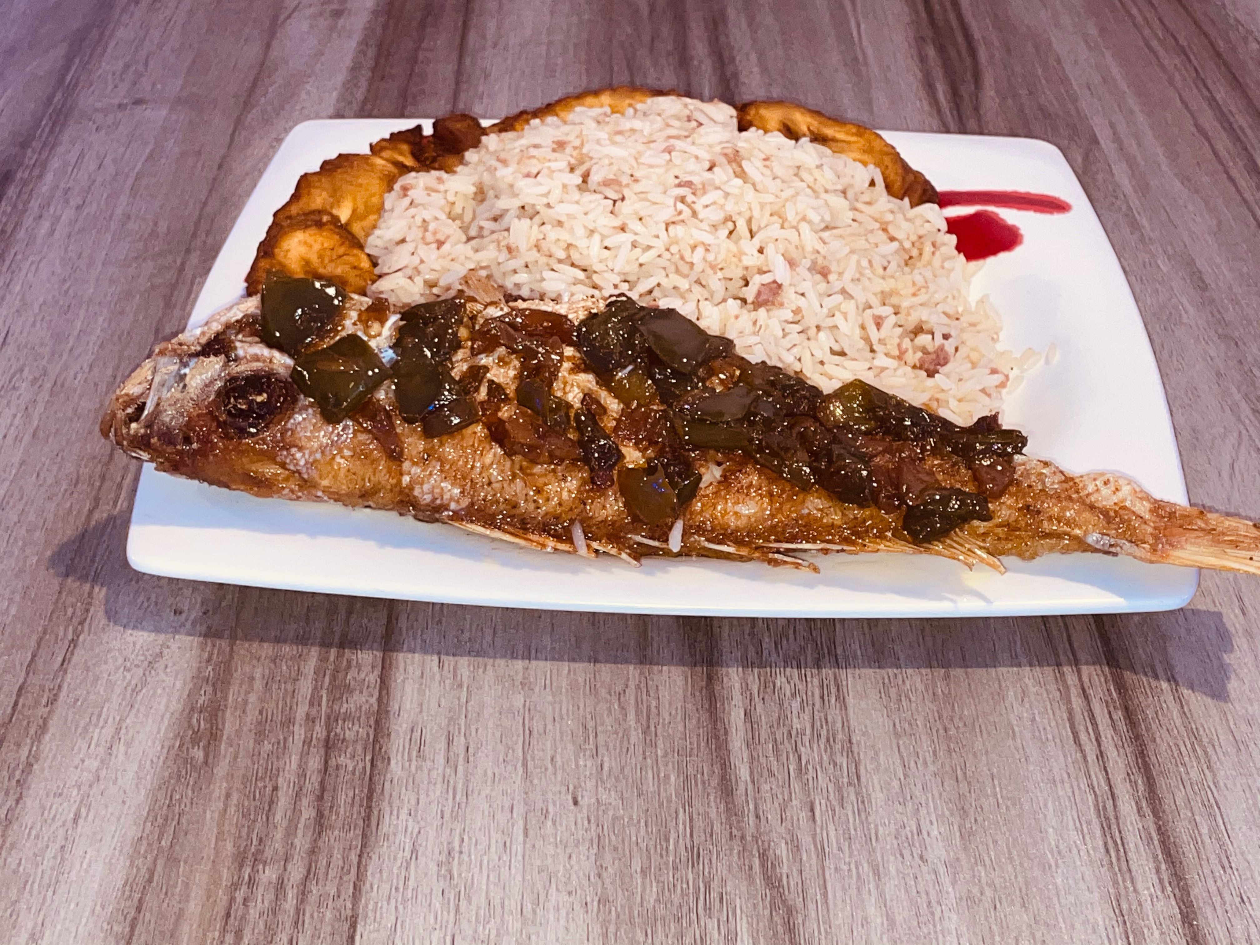 Order Signature dry rice with red snapper fish and fried sweet plantains  food online from Food Geez Restaurant store, Philadelphia on bringmethat.com
